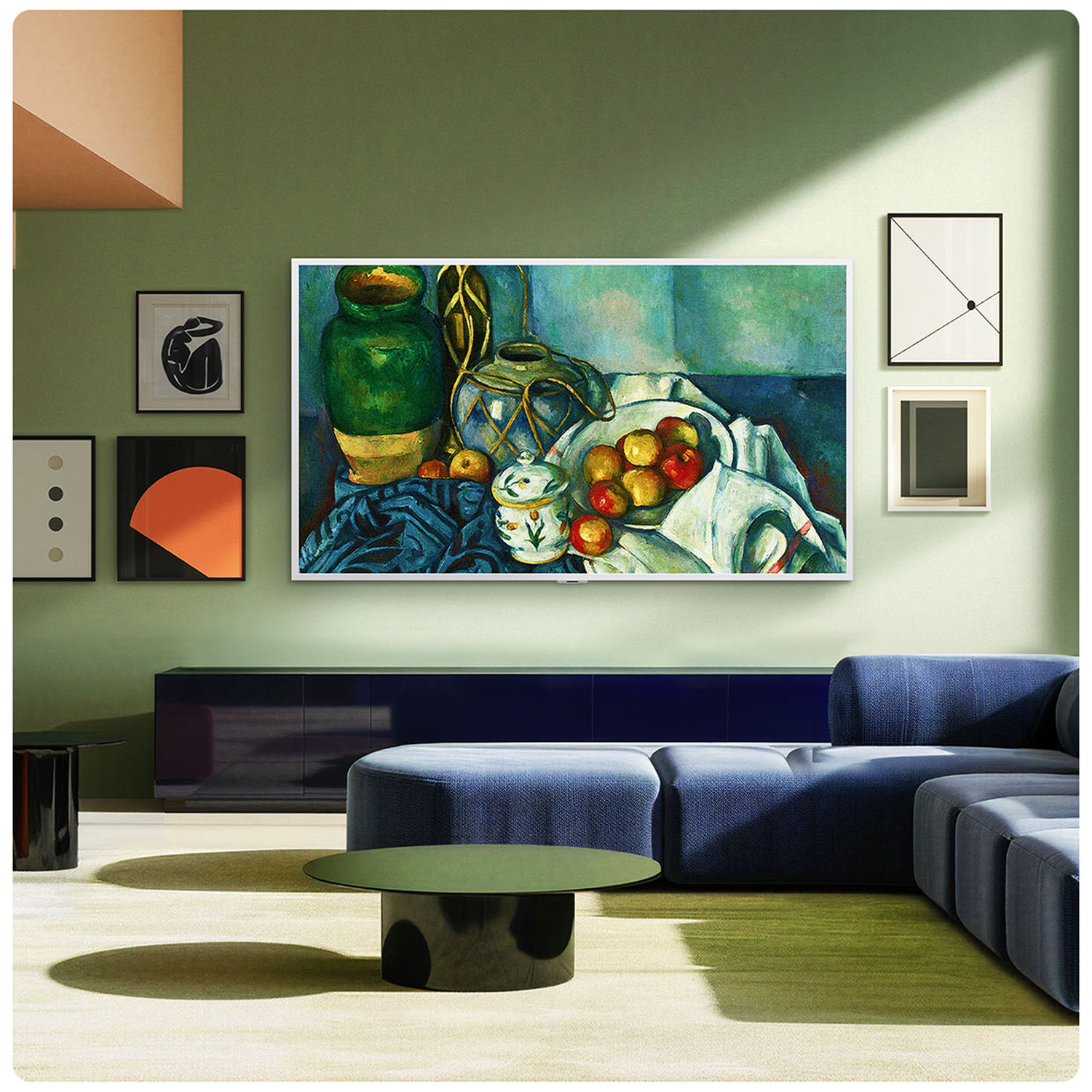 A living room with a painting of fruit, green vase, and fabric on a canvas.