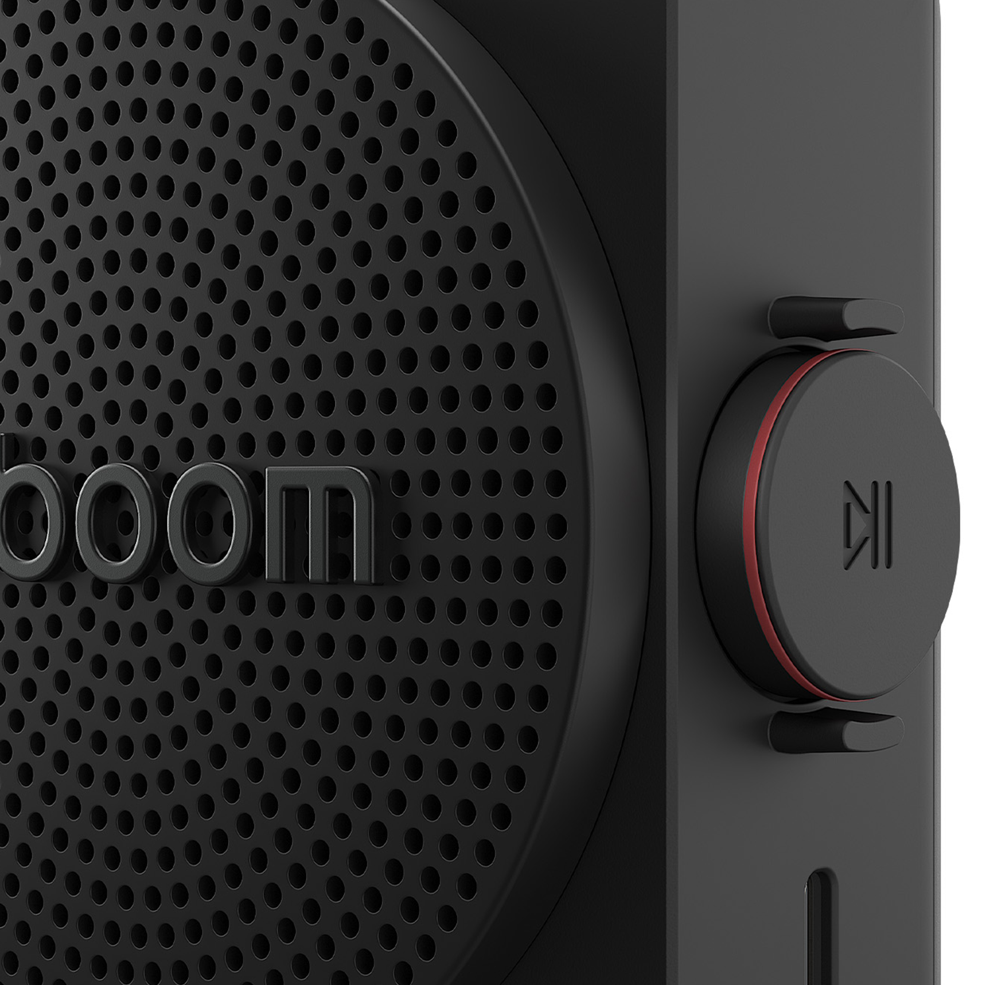 Altavoz negro con patrón de agujeros y un anillo rojo en un botón redondo.
