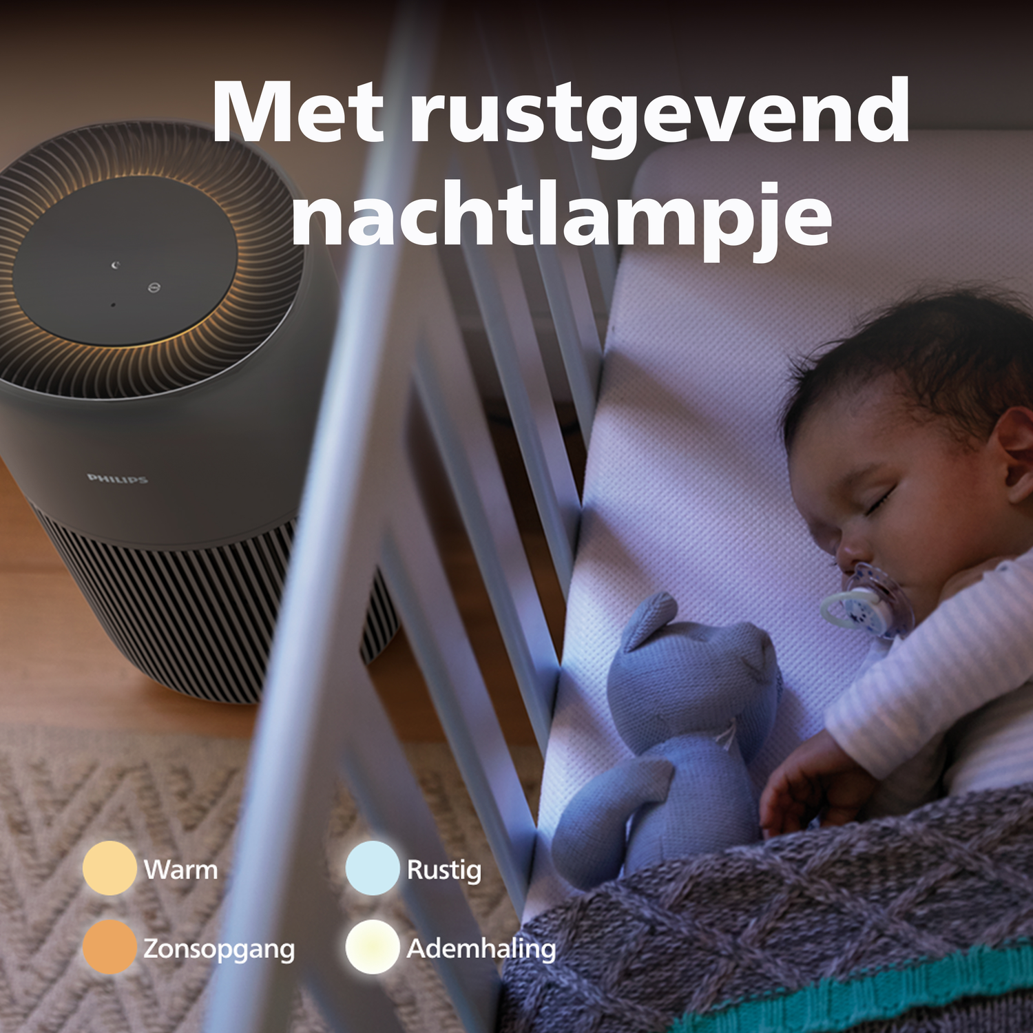 A baby sleeps in a crib next to an air purifier and a teddy bear.