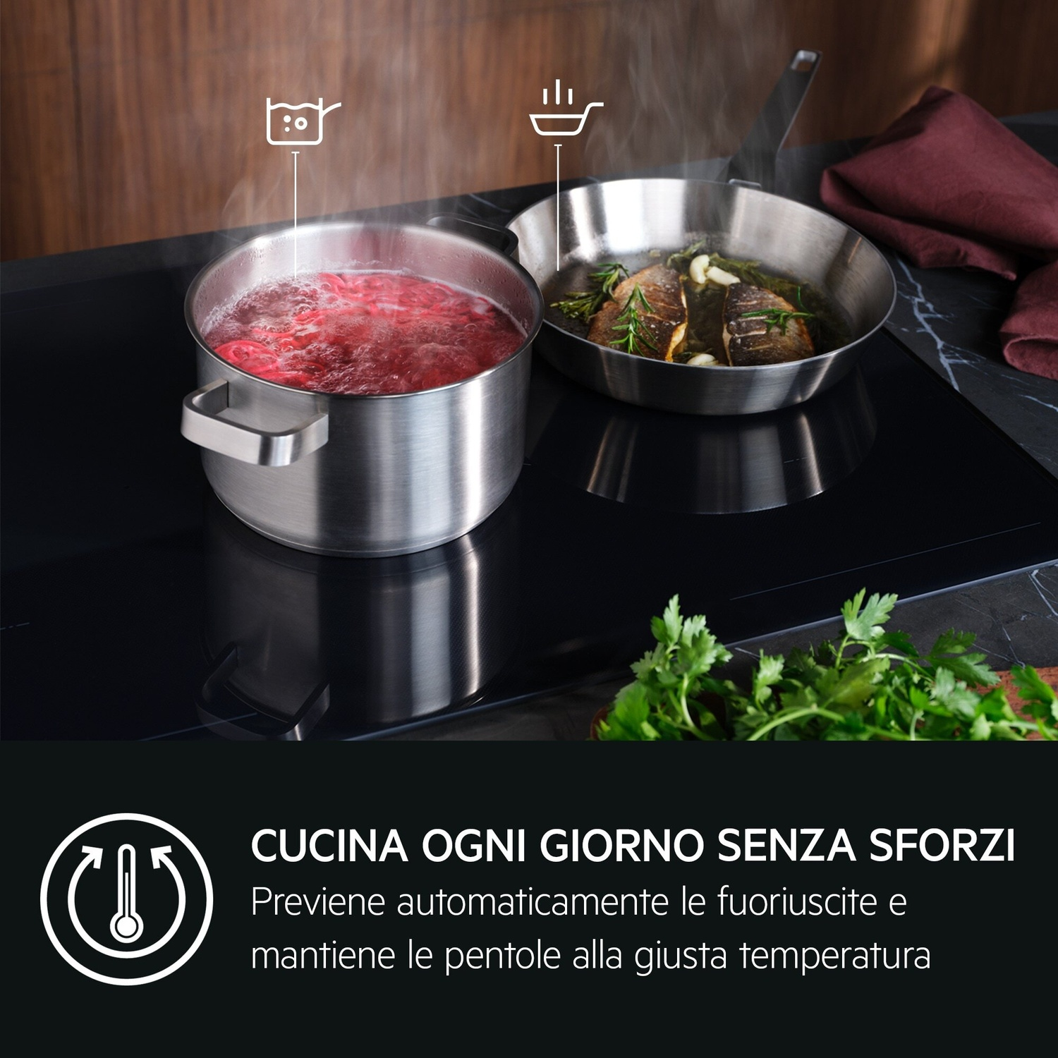 Una pentola di acqua bollente e una padella con pesce su un piano cottura a induzione.