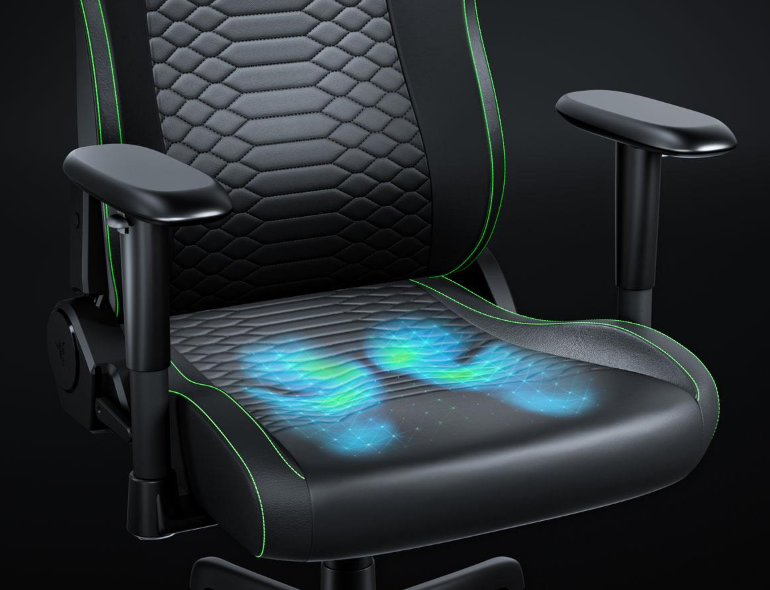 Czarny fotel gamingowy z zielonymi lamówkami i niebieskimi efektami świetlnymi na siedzeniu.