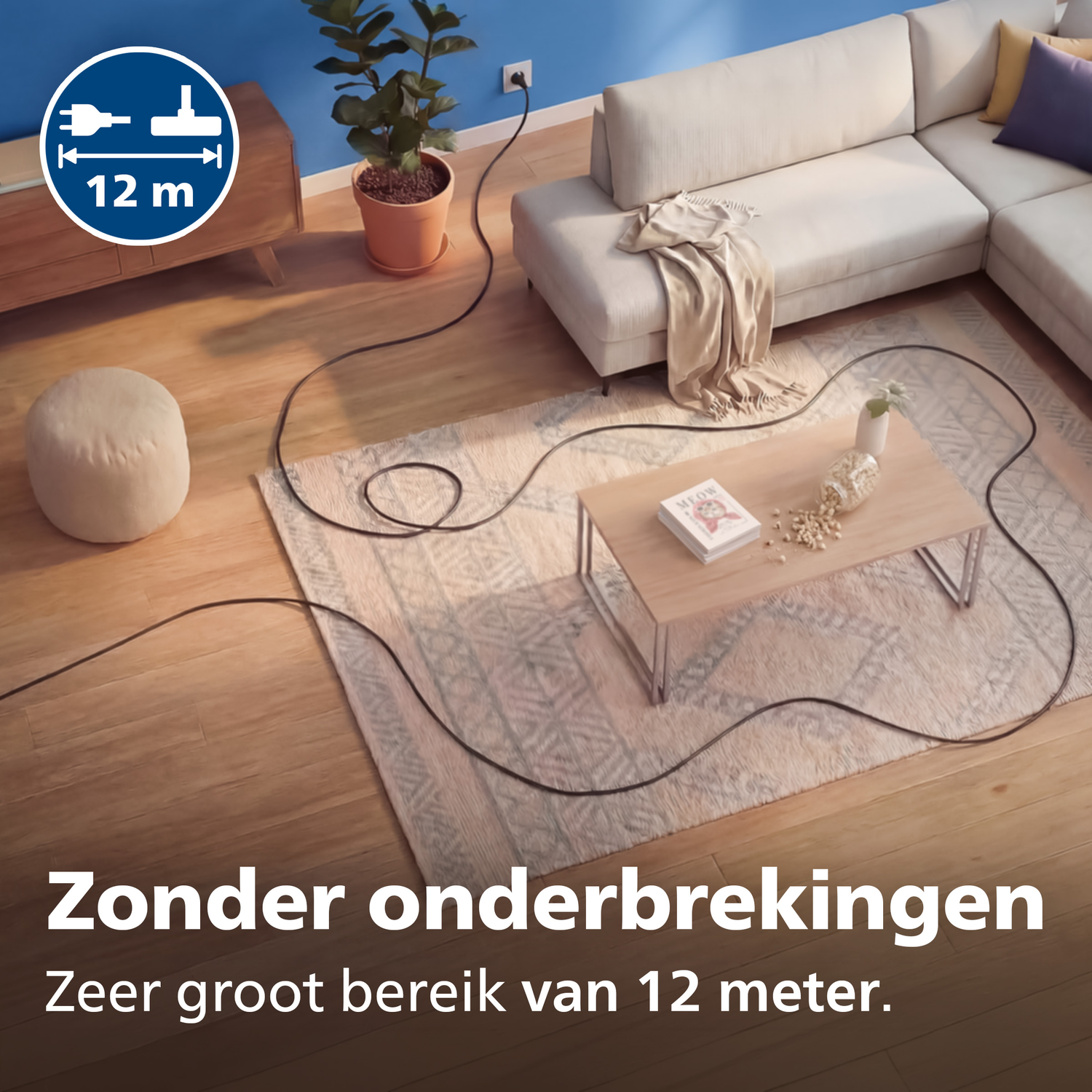 A long black cable runs across a living room from an outlet to a sofa.