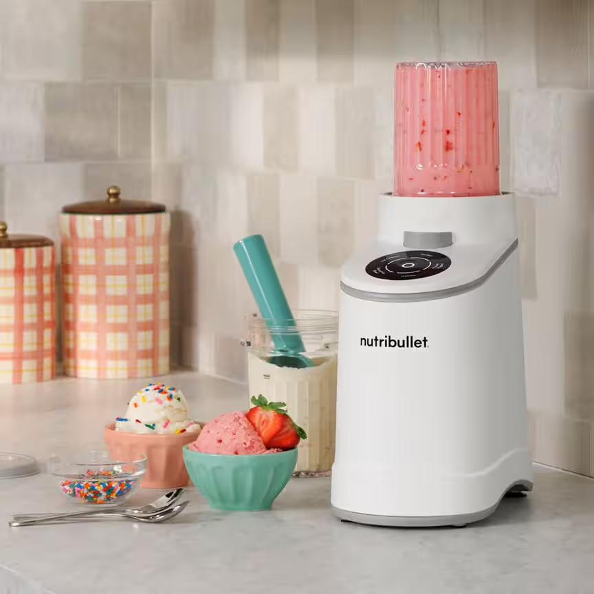 Fehér Nutribullet turmixgép fagylaltos és szórócukros tálkák mellett.