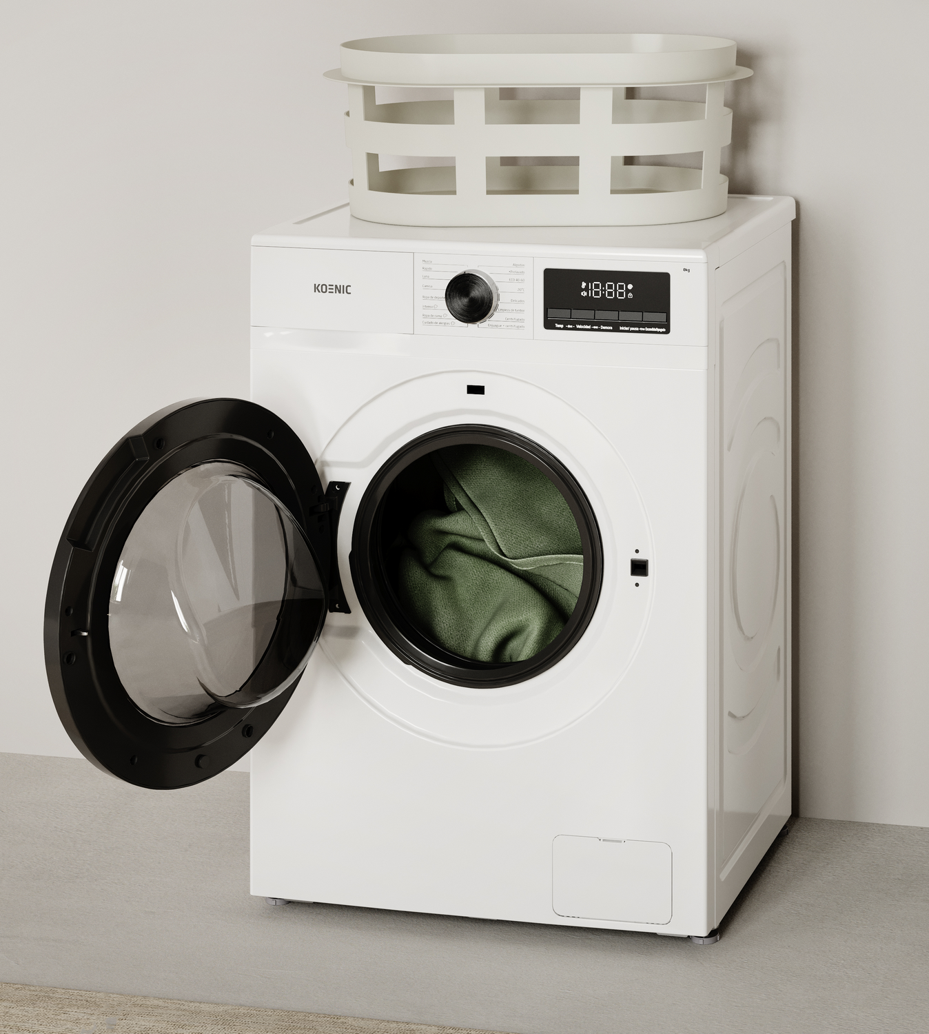 Una lavadora blanca con puerta abierta, con ropa verde dentro. Encima hay una cesta blanca.