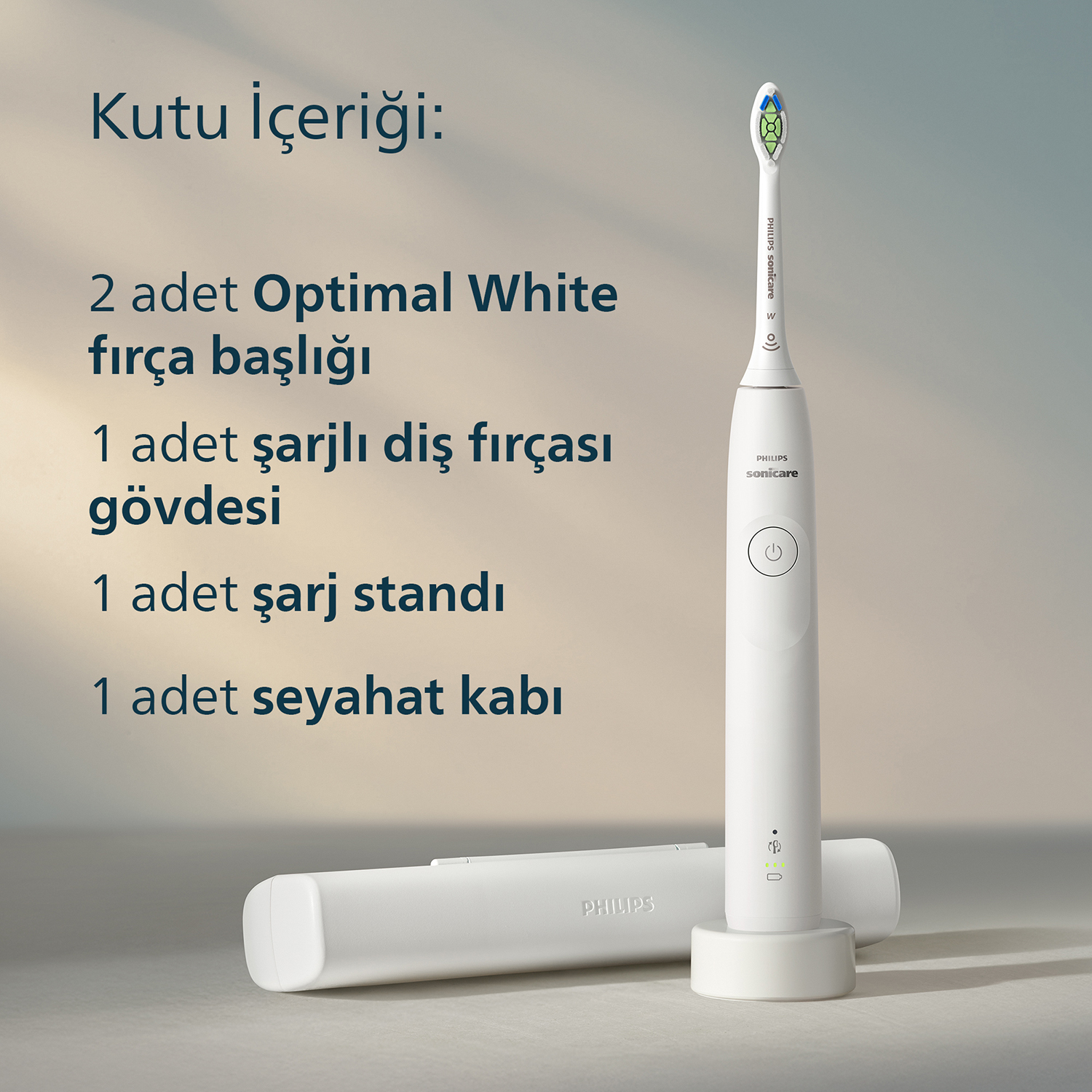 Beyaz elektrikli diş fırçası, şarj cihazı, iki başlık ve seyahat kabı.