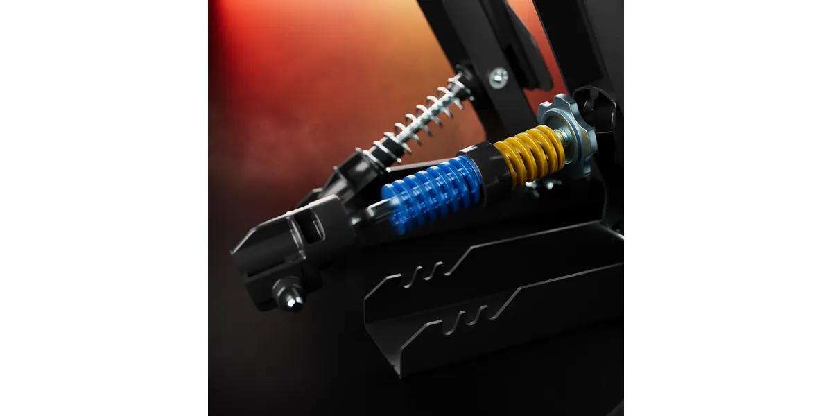 Nahaufnahme eines schwarzen mechanischen Geräts mit blauen und gelben Federn, rotem Hintergrund.
