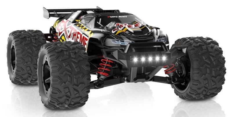 Czarny monster truck z czerwonymi amortyzatorami i światłami.