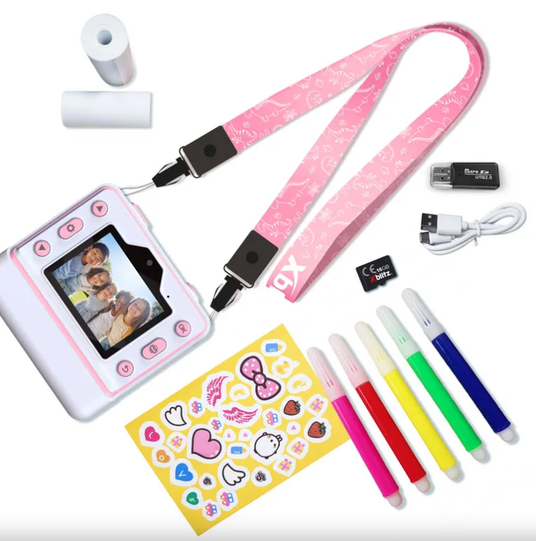 Biały aparat cyfrowy z różową smyczą z dinozaurami, naklejkami, pisakami i akcesoriami.