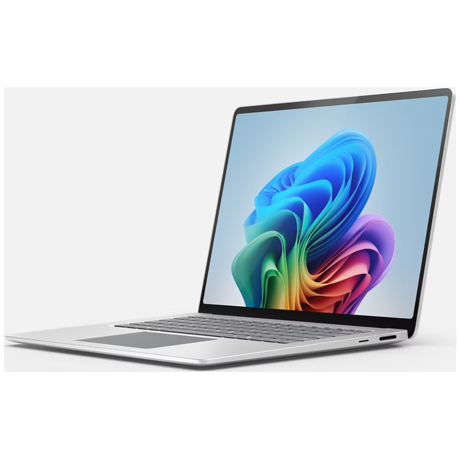A silver laptop displaying a colorful abstract background on its screen.