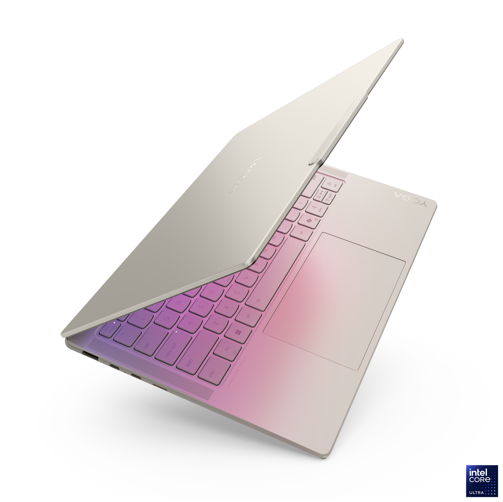 Pembe ve mor tonlarda arkadan aydınlatmalı tuşlara sahip bej Lenovo Yoga dizüstü bilgisayar.