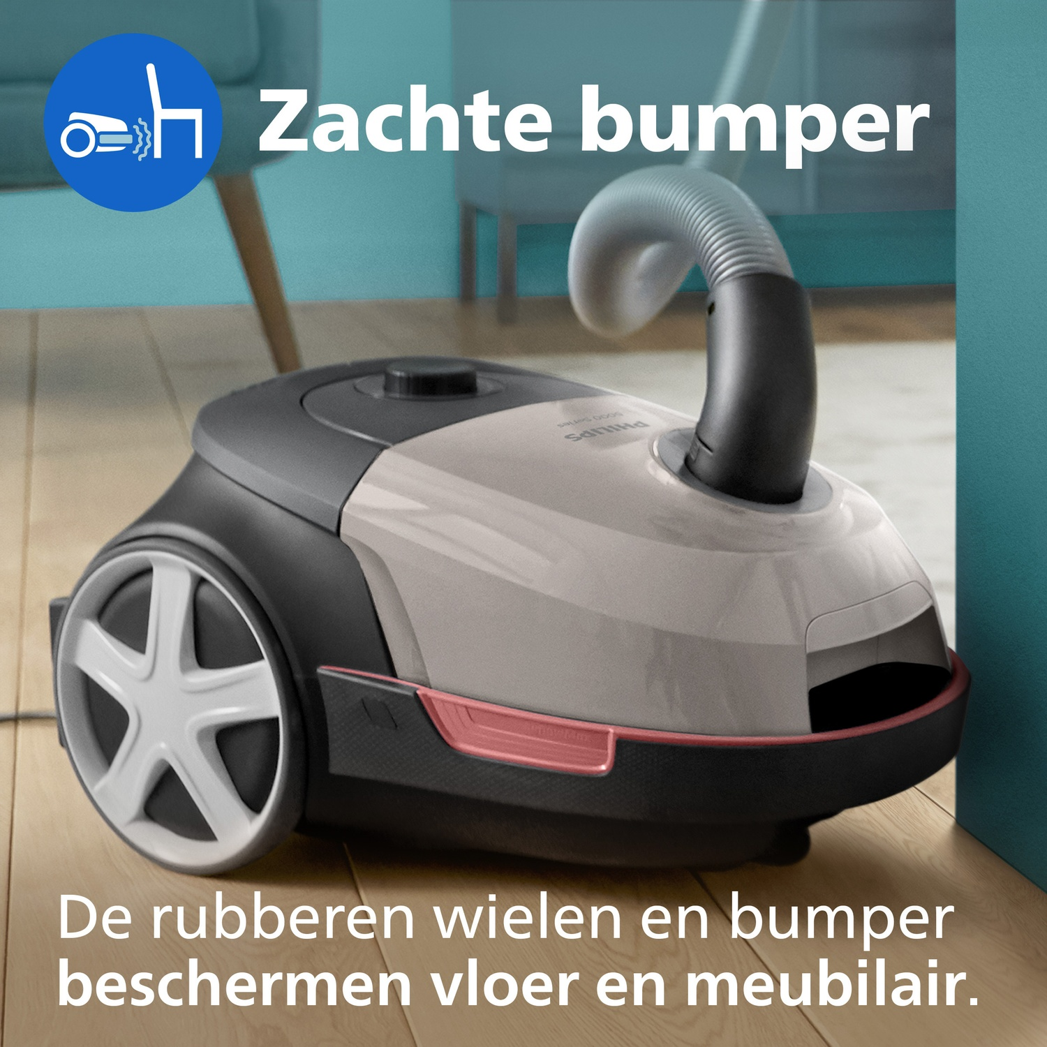 A Philips vacuum cleaner with a soft bumper and rubber wheels on a wooden floor.