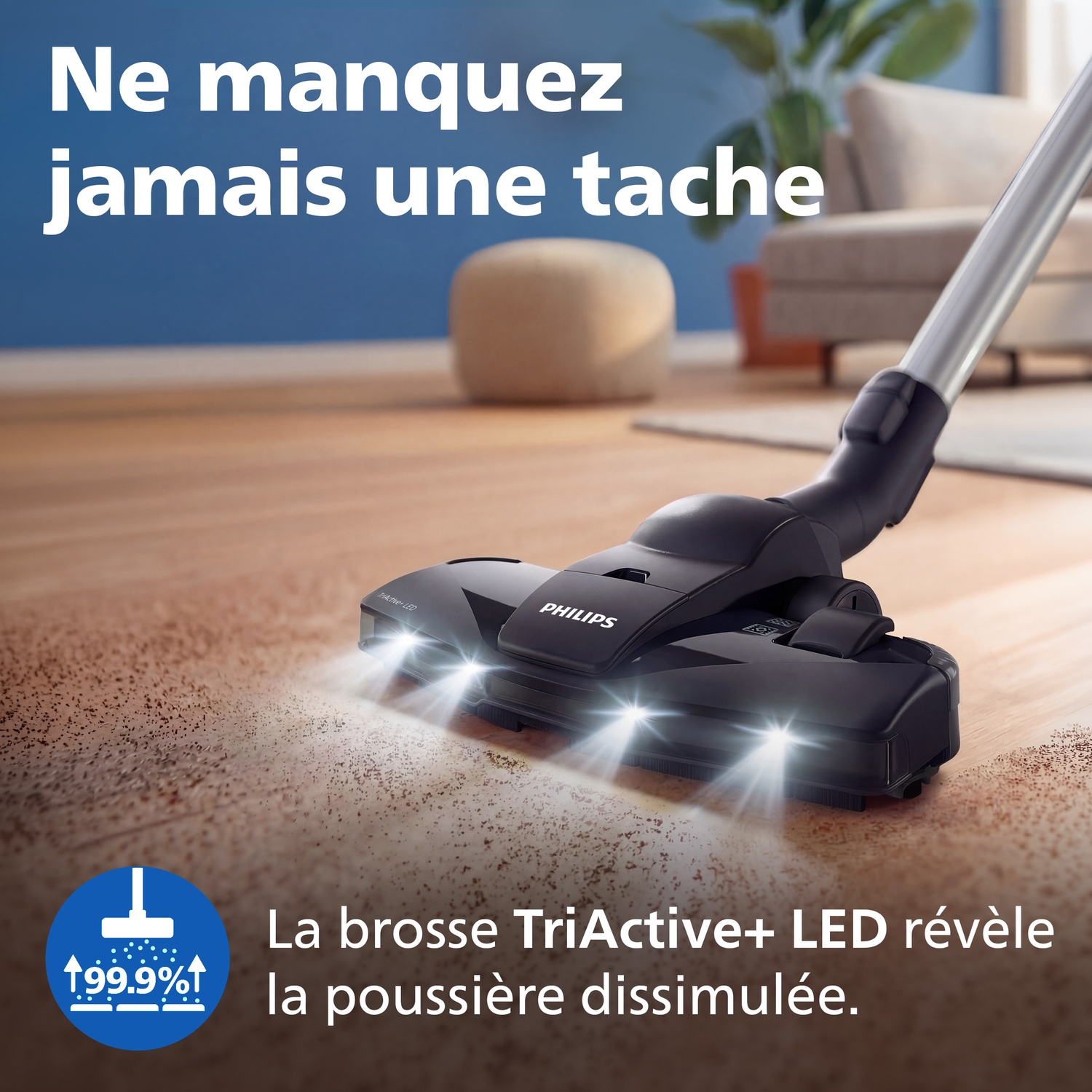 Une tête d'aspirateur Philips avec LED nettoie un parquet poussiéreux.