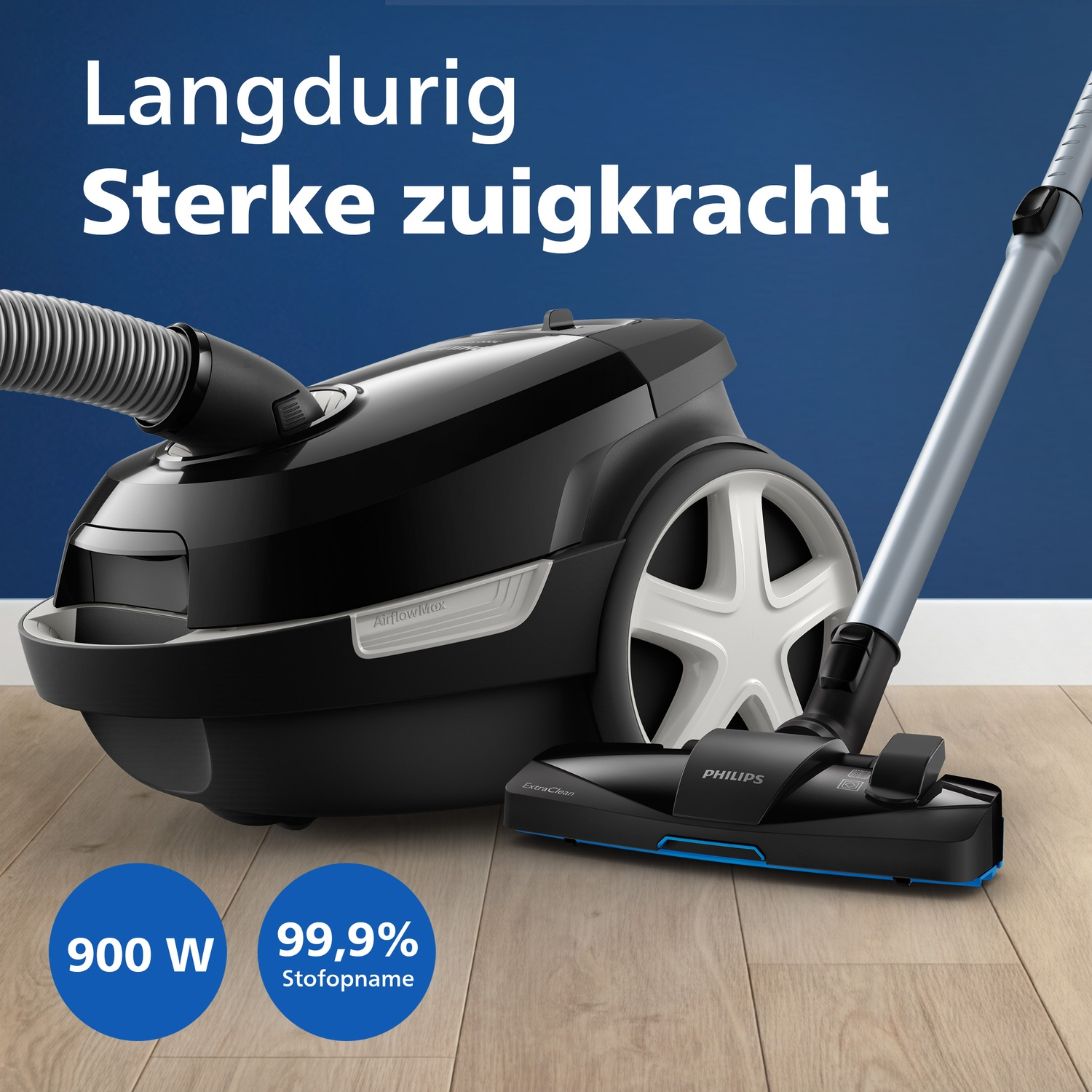 A black Philips vacuum cleaner with strong suction power on a wooden floor.