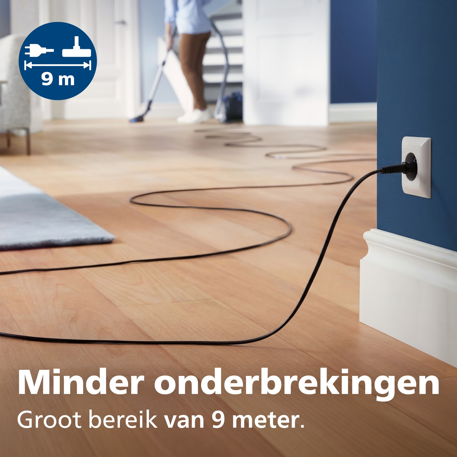 A vacuum cleaner cord with 9m reach plugged into an outlet.