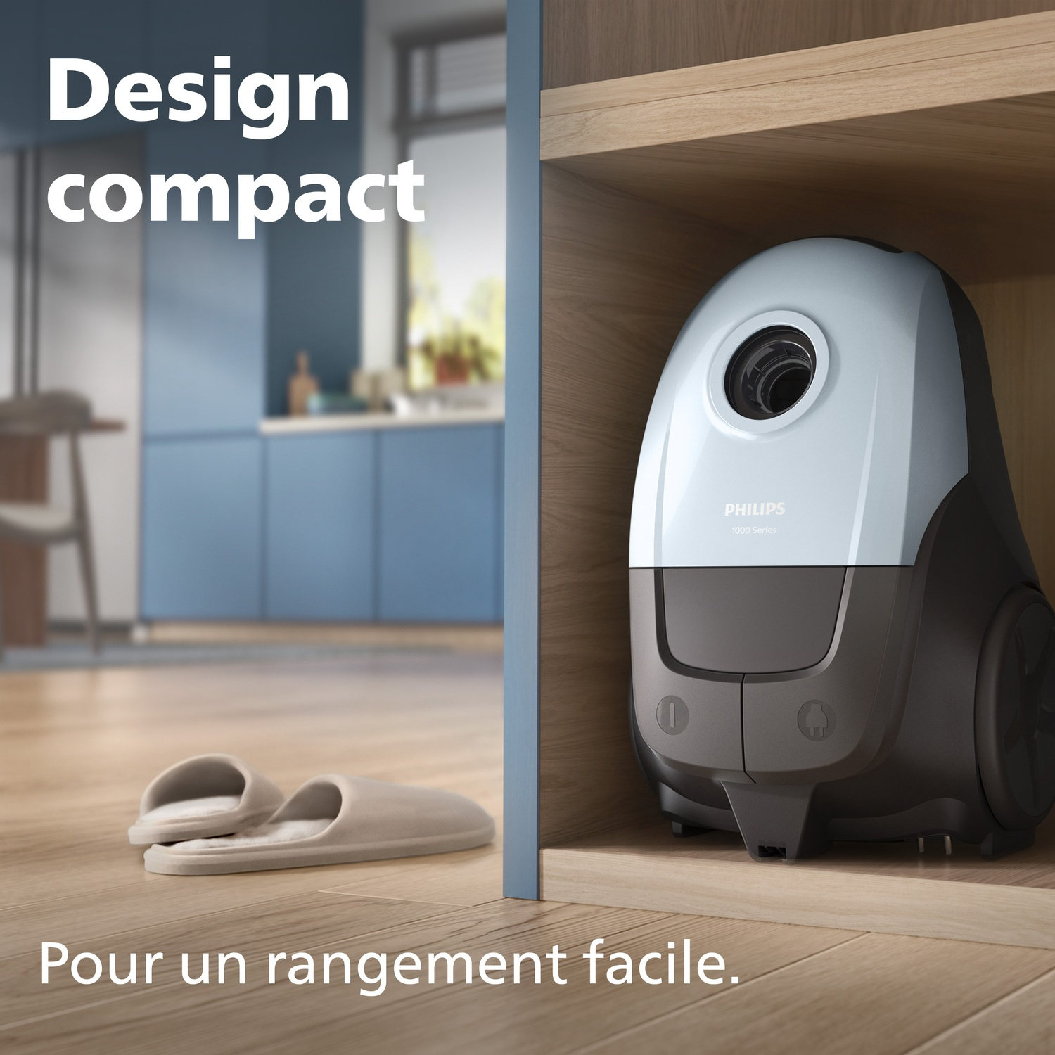 A compact Philips vacuum cleaner on a shelf, with slippers nearby.