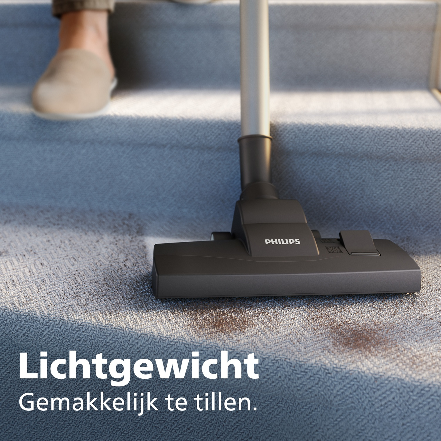 A vacuum cleaner head cleans a dirty carpet on stairs. Light weight.
