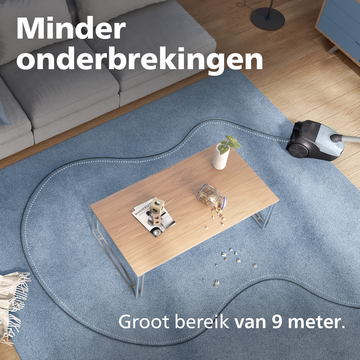 A vacuum cleaner with its cord on a blue rug near a wooden coffee table.