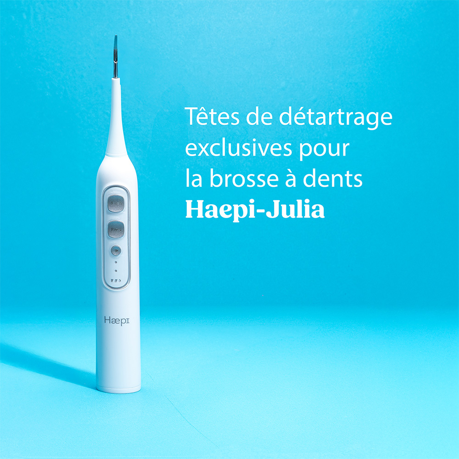 Een wit tandheelkundig hygiëneapparaat met Hæpi-logo en tekst op blauwe achtergrond.