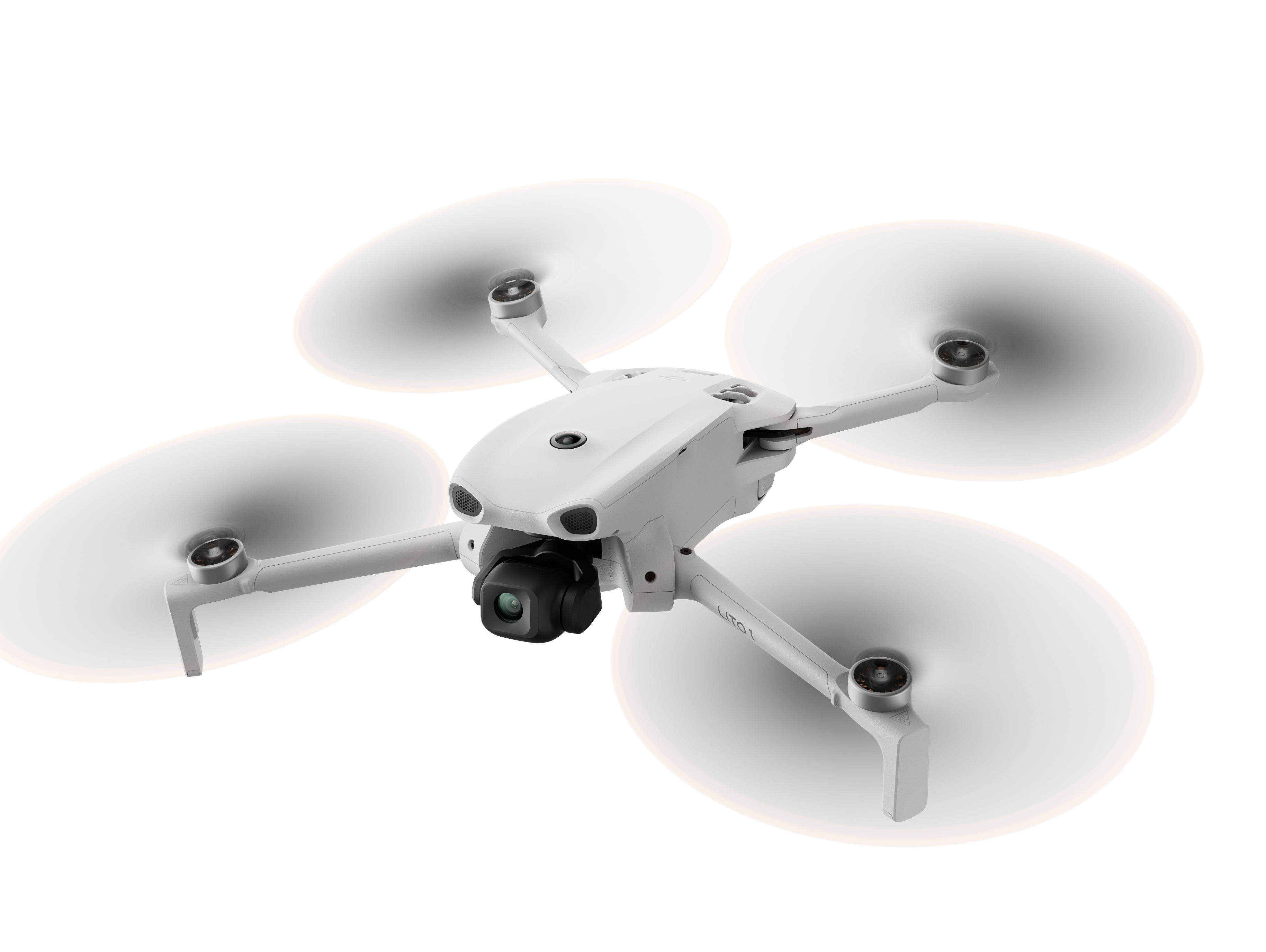 Biały dron z czterema śmigłami i kamerą unosi się w locie.