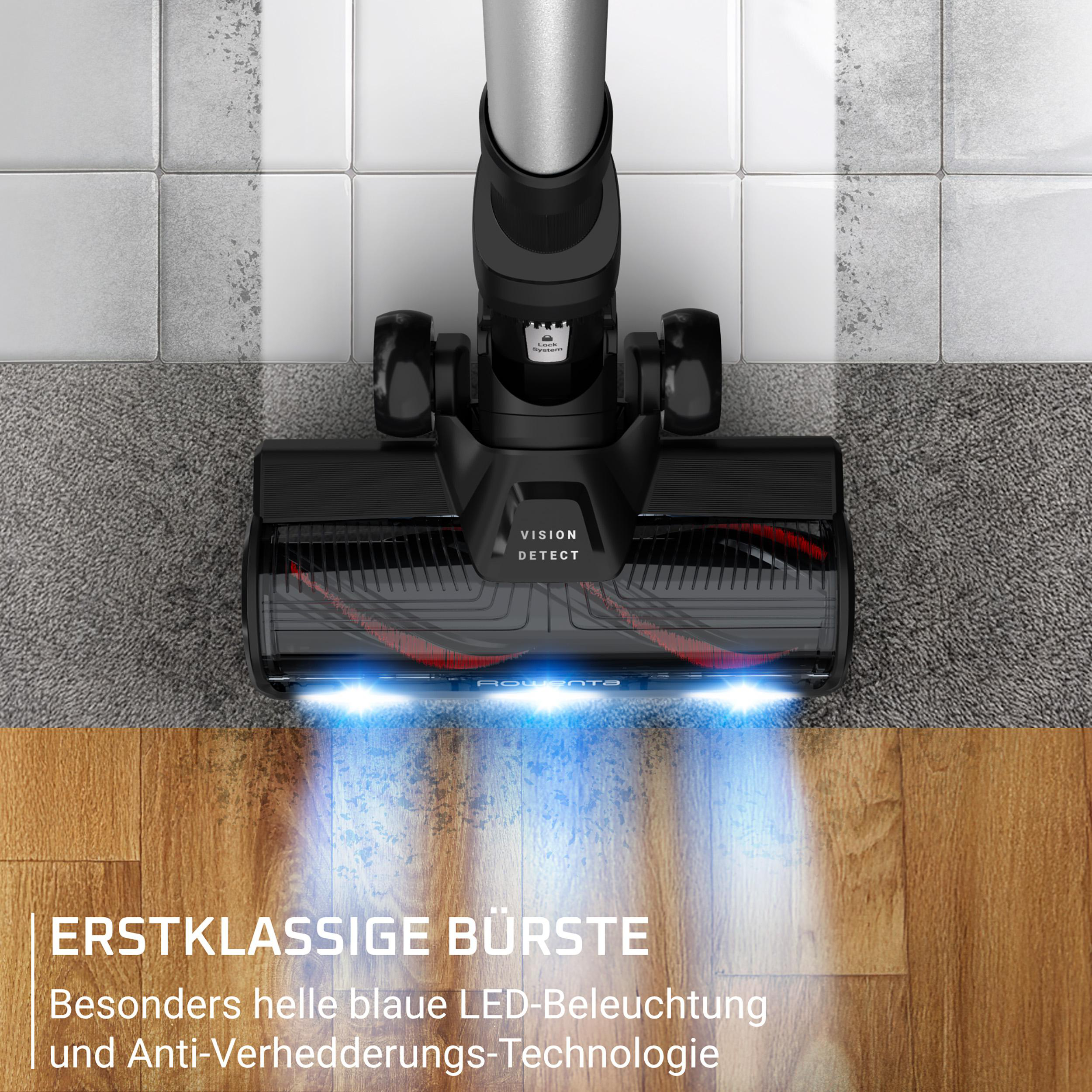 Staubsaugerbürste mit blauen LEDs auf Holz und Teppich.