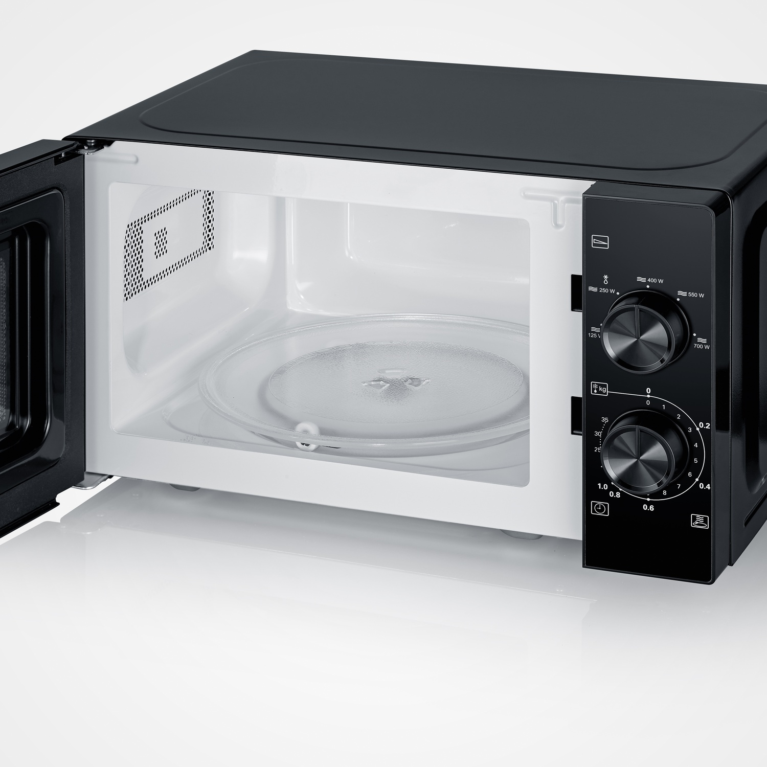 A black microwave with its door open, showing the turntable and control panel inside.