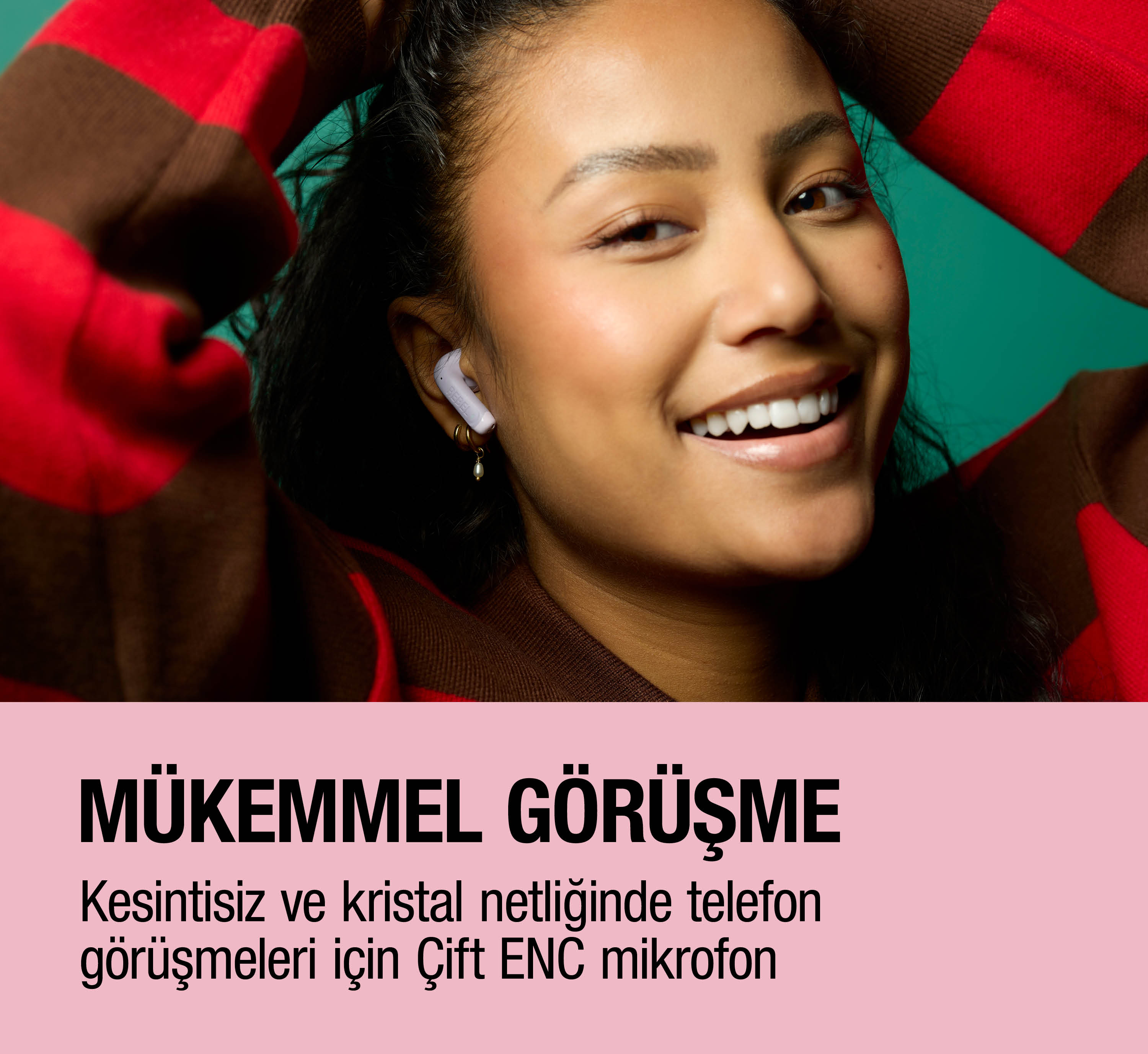 Kulaklıkla bir kadın turkuaz fon önünde gülümsüyor.