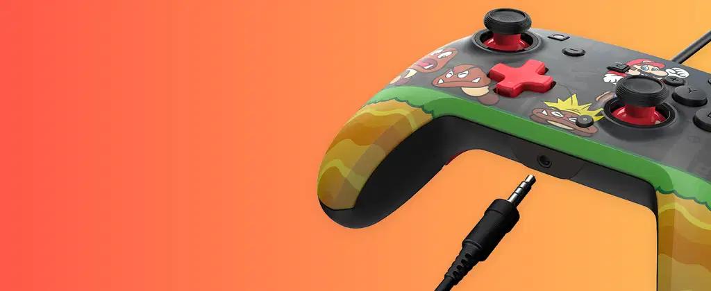Nahaufnahme eines schwarzen Nintendo-Controllers mit Mario-Figuren und Goombas auf orangefarbenem Farbverlauf.