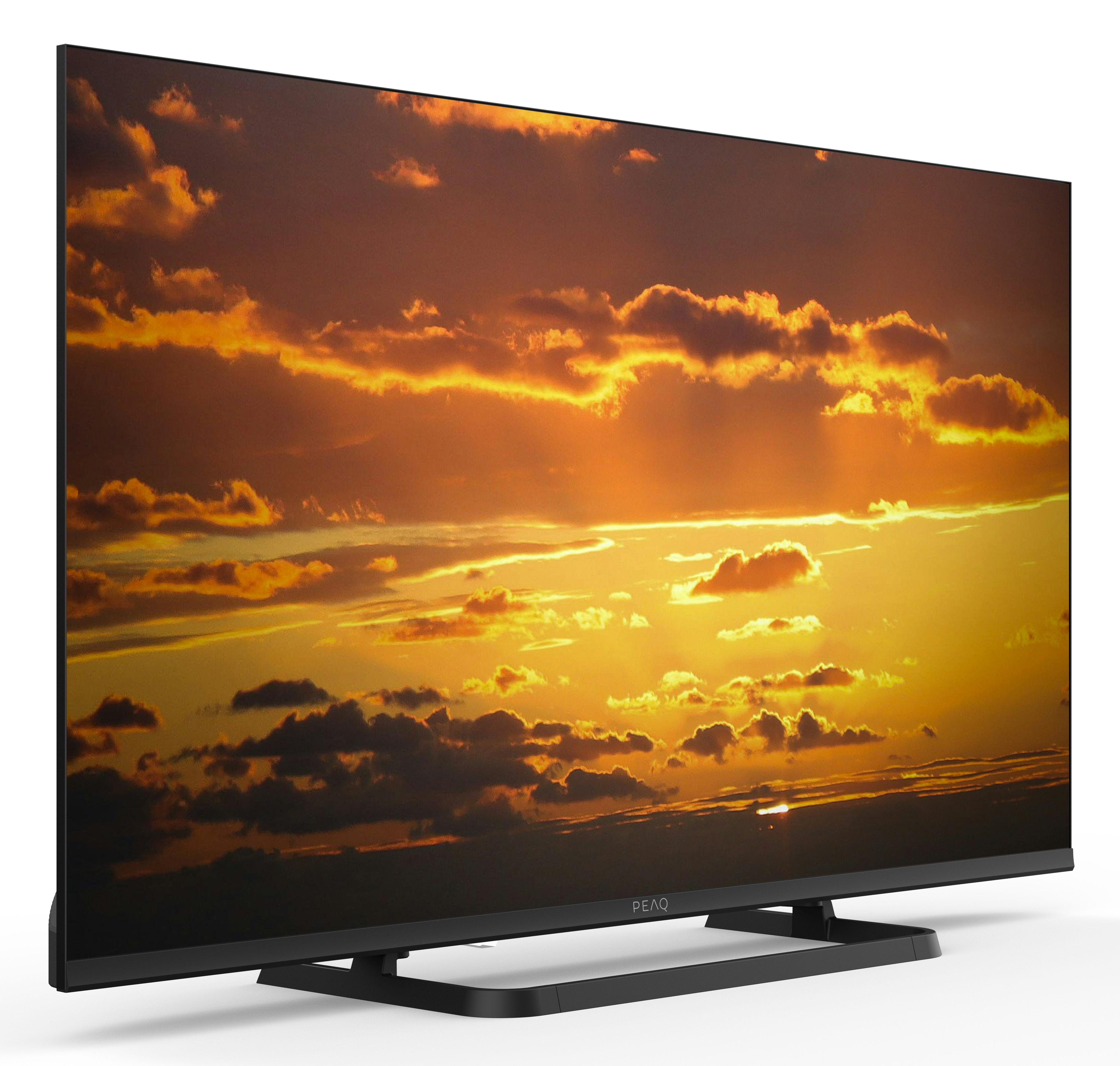 Nowoczesny telewizor wyświetlający dramatyczny zachód słońca na ekranie.