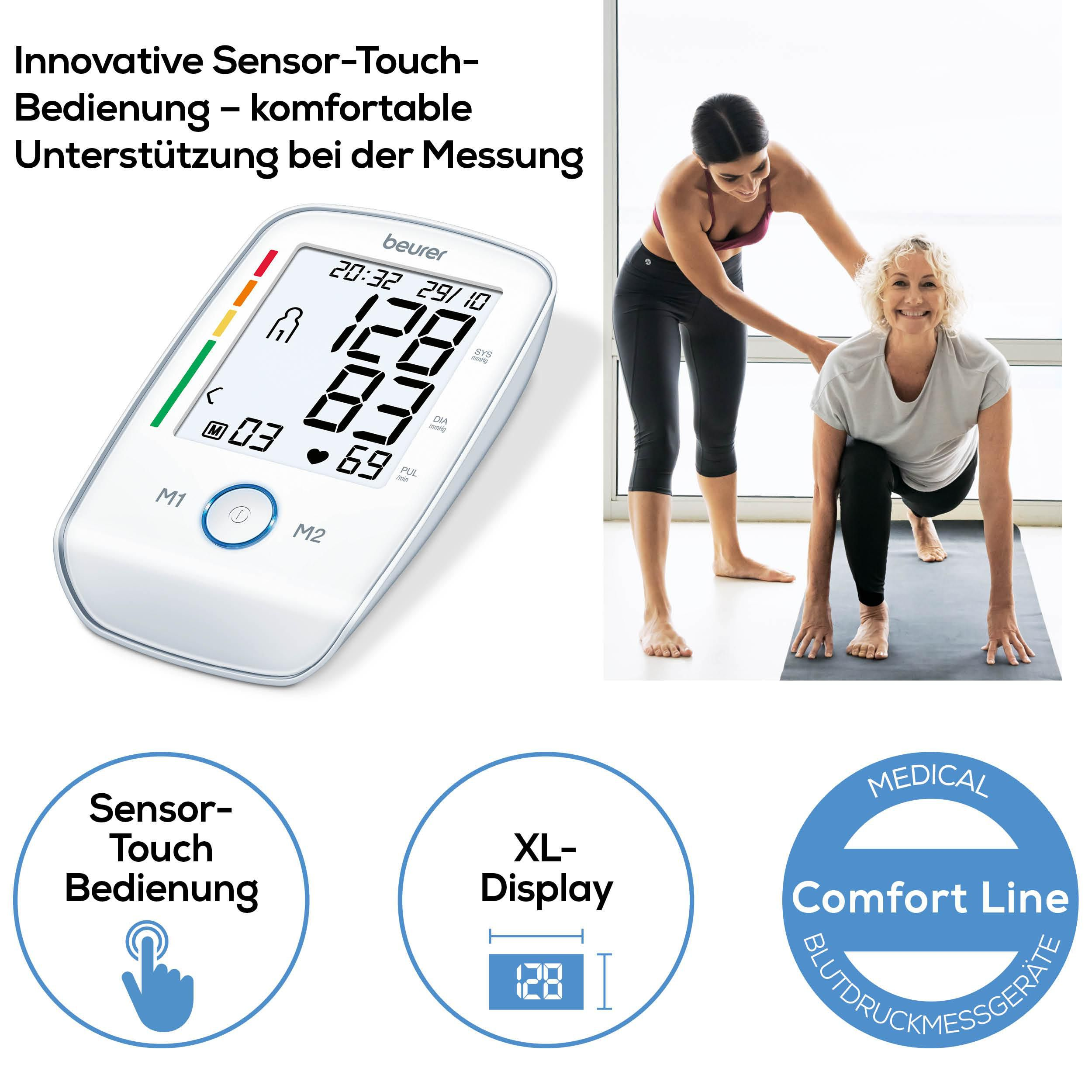 Ein Beurer Blutdruckmessgerät mit XL-Display und zwei Frauen bei Yoga.