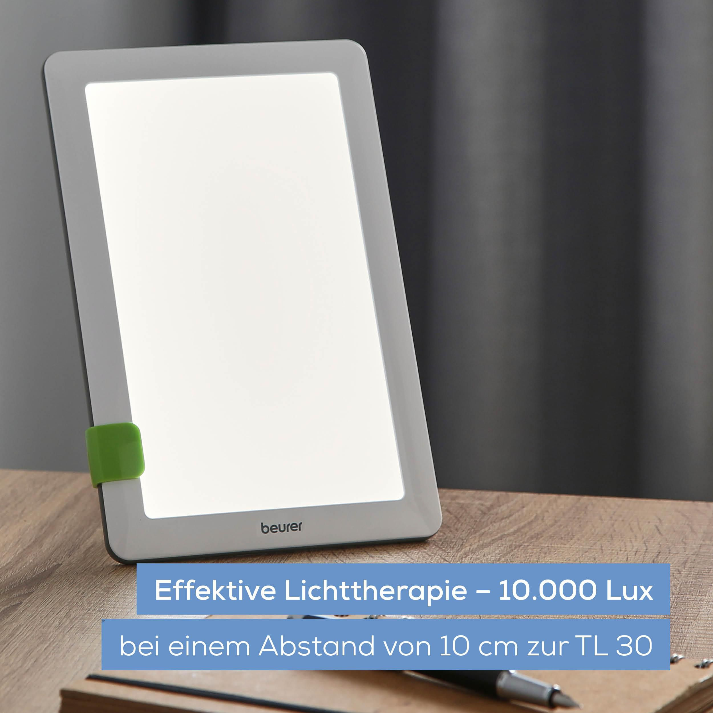 Ein Beurer Lichttherapiegerät mit 10.000 Lux auf einem Holztisch.