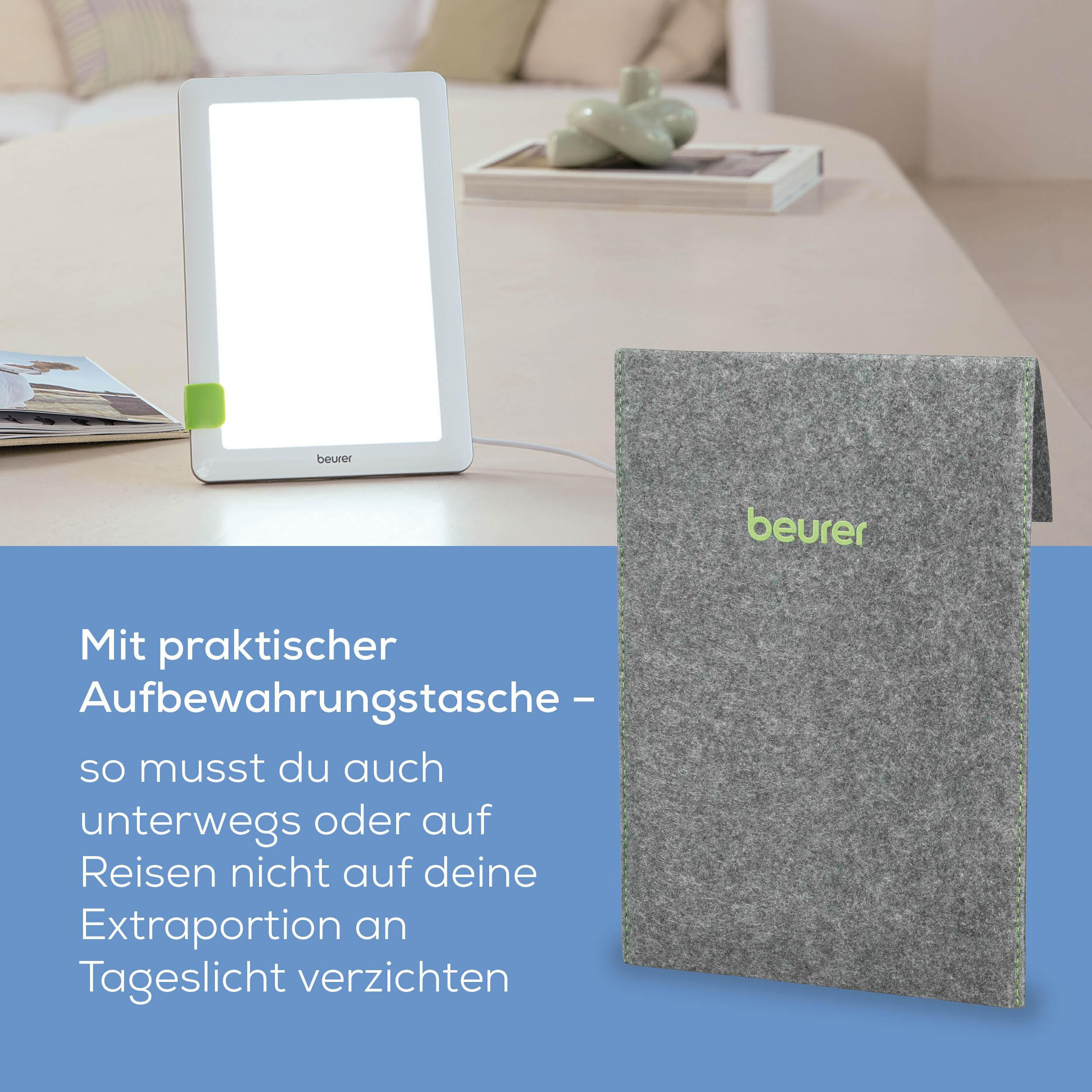 Eine helle Tageslichtlampe und eine graue Aufbewahrungstasche stehen auf einem Tisch.