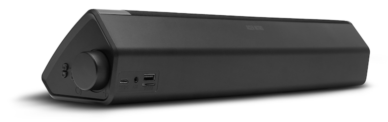 Barra de sonido negra con control de volumen y puertos.