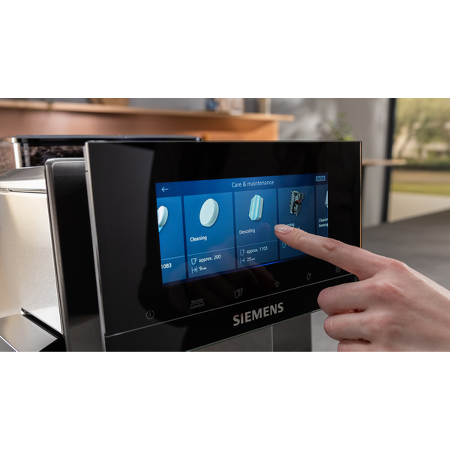 A hand touches a coffee machine screen displaying maintenance options.