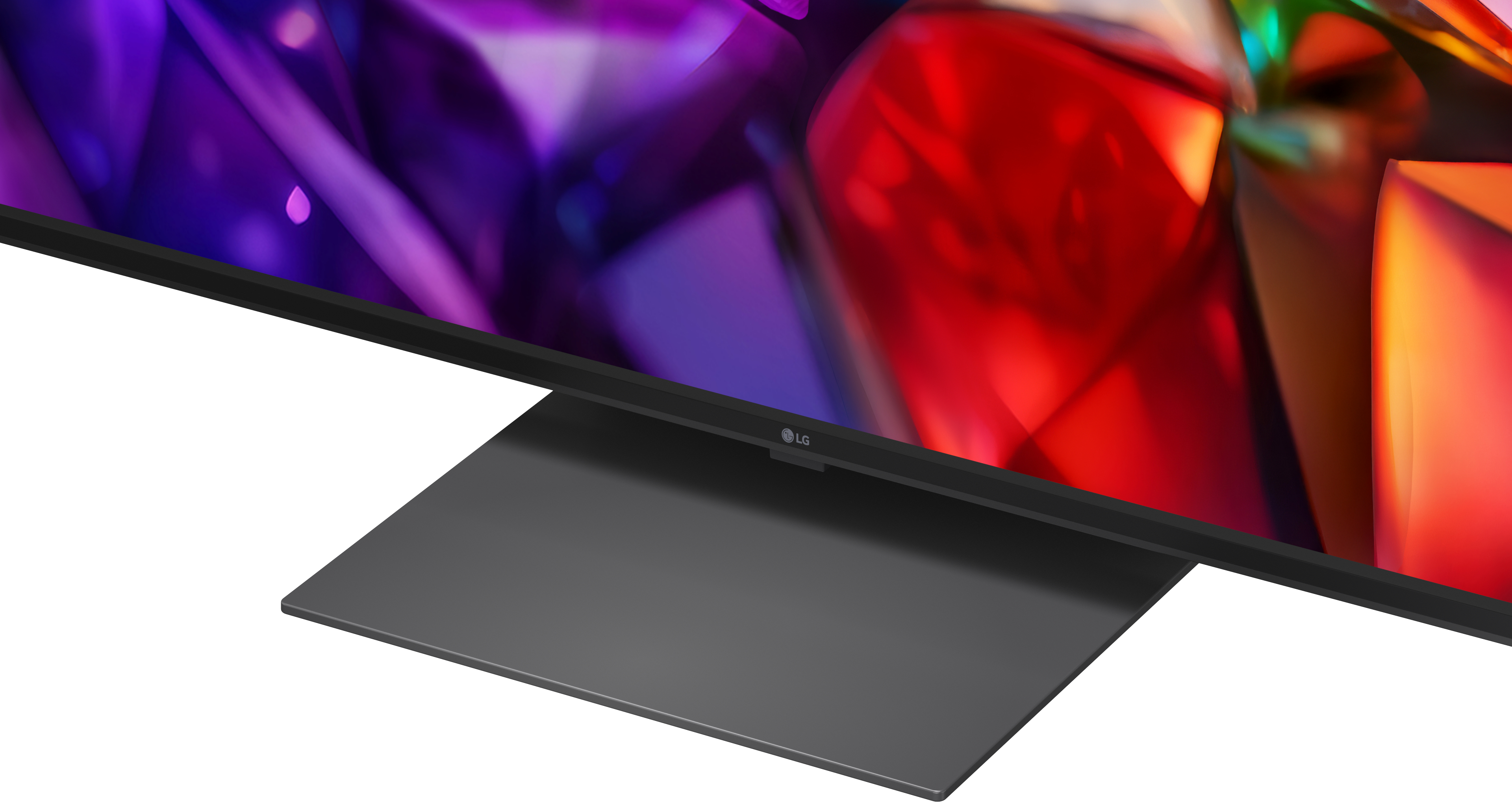 Ein LG-Fernseher mit einem abstrakten, bunten Hintergrund und einem grauen Sockel.