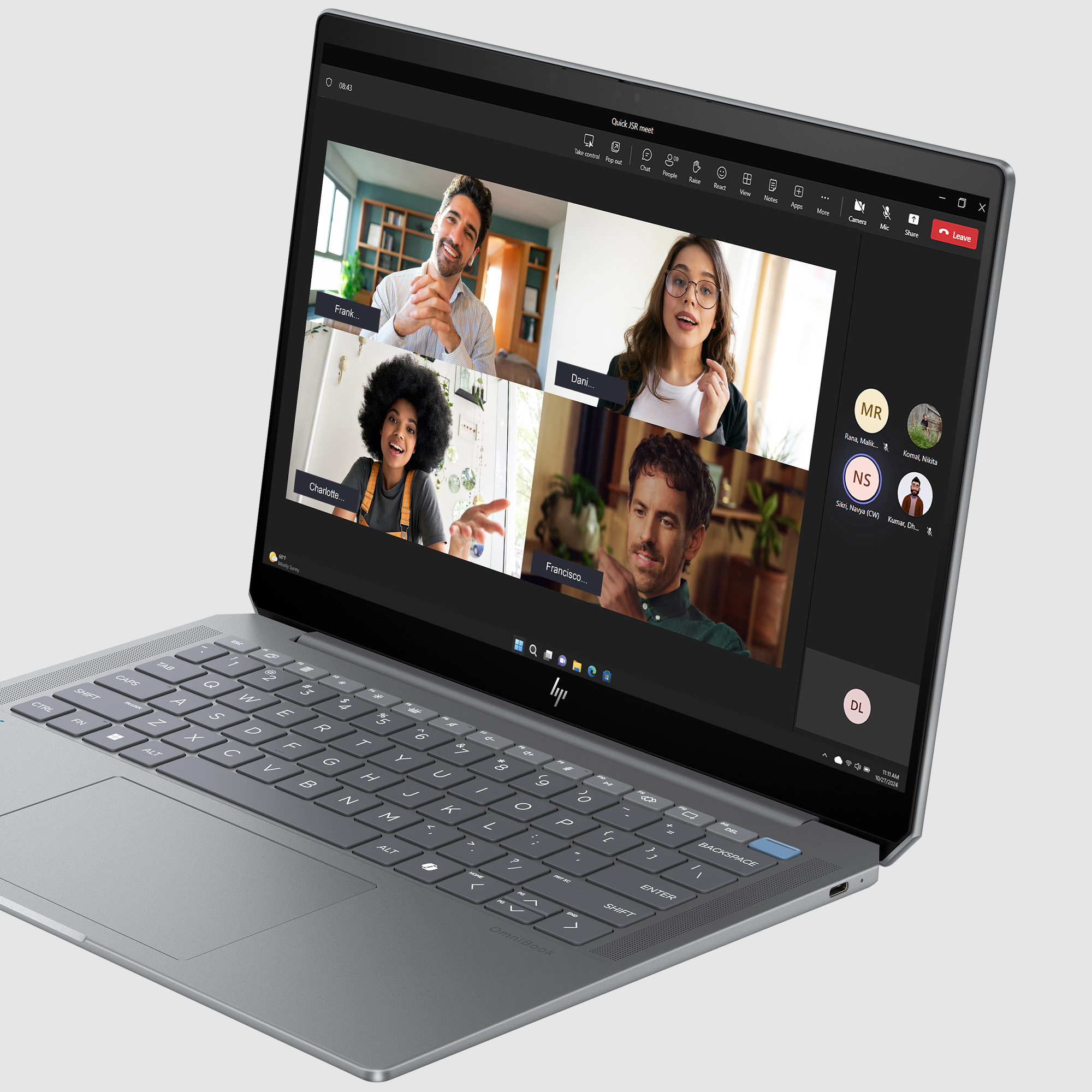 Laptop wyświetla wideokonferencję z czterema uczestnikami. Klawiatura widoczna.