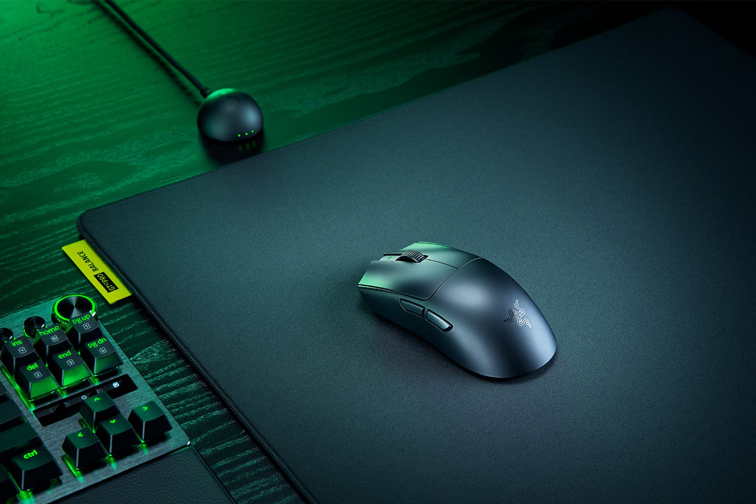 Un tappetino per mouse gaming nero con mouse e tastiera in primo piano.