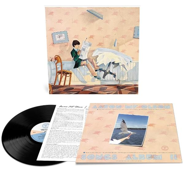 Eine Schallplatte und ein Albumcover mit einem Jungen, der liest, und einem Seevogel.