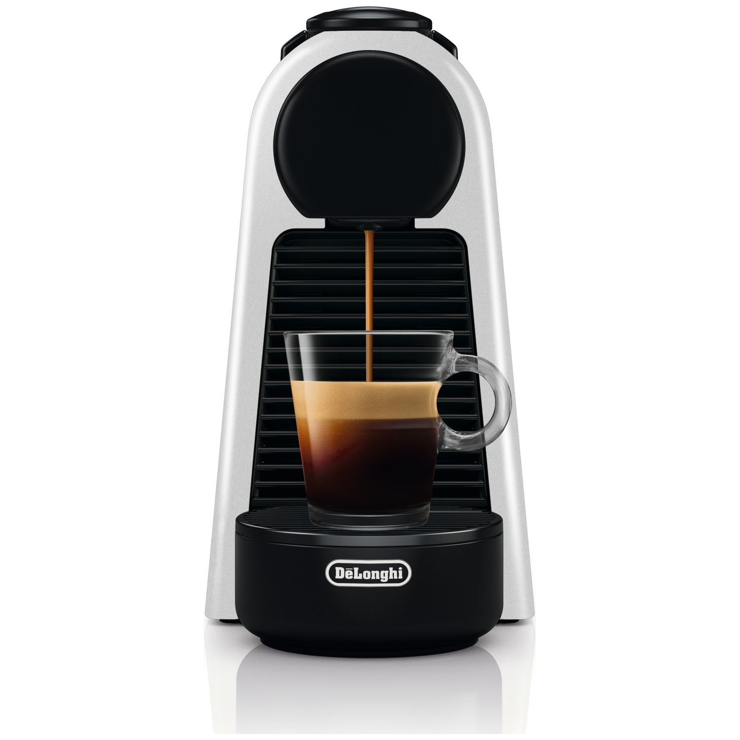 A silver DeLonghi espresso machine brews coffee into a glass cup.