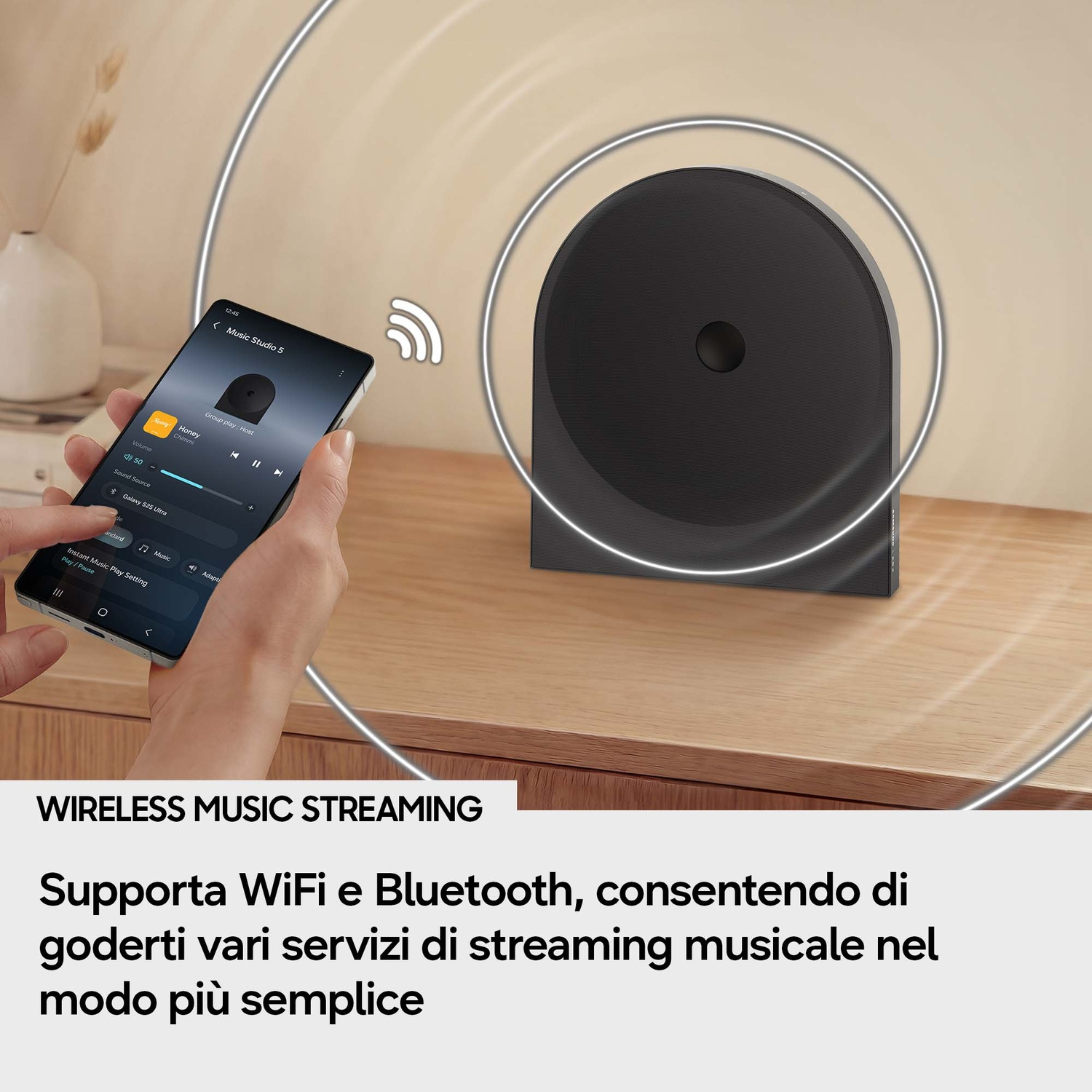 Uno smartphone controlla un altoparlante nero con linee ondulate.