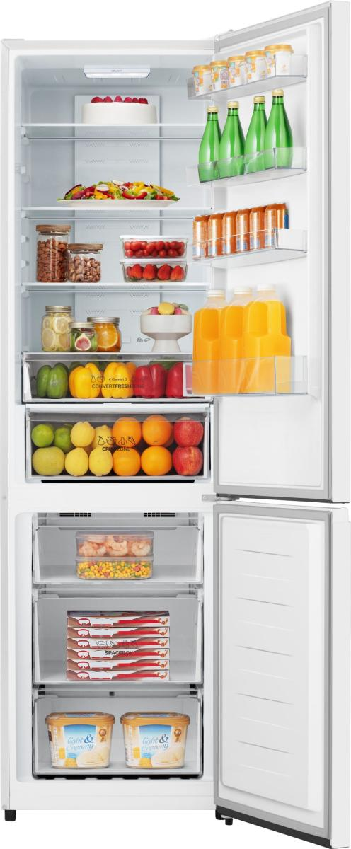 Otwarta lodówka wypełniona jedzeniem: ciasto, sałatka, owoce, warzywa, sok i lody.