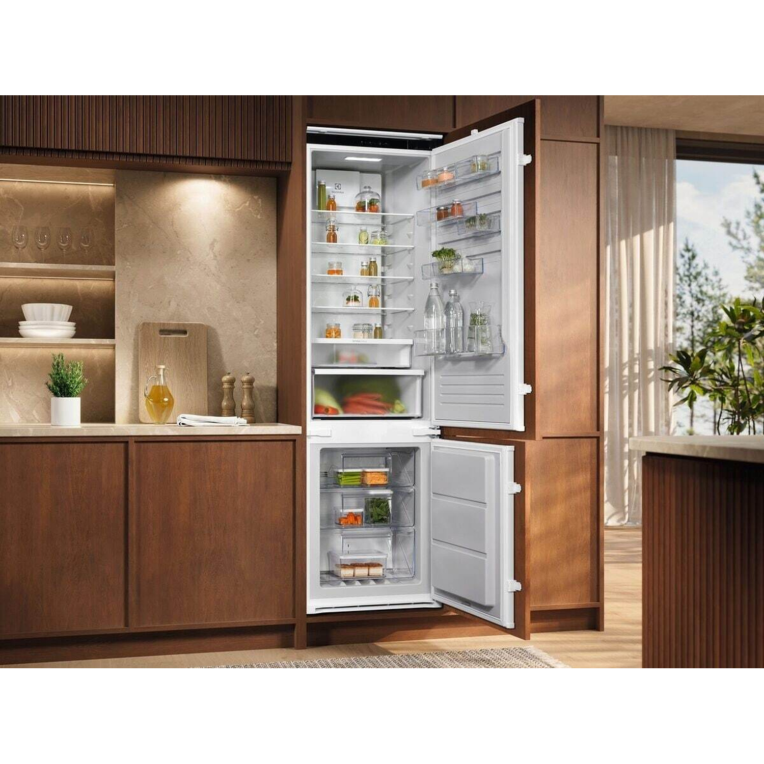 Frigorifero da incasso con porta aperta, pieno di cibo. Cucina moderna.