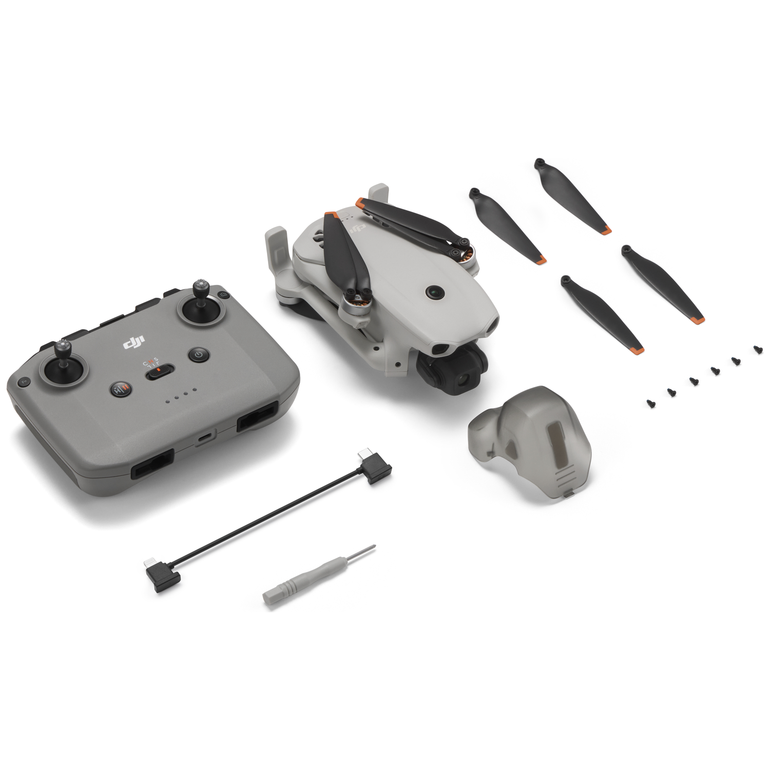 Gray DJI Mini 3 Pro drone kit with controller, spare propellers, and screws.