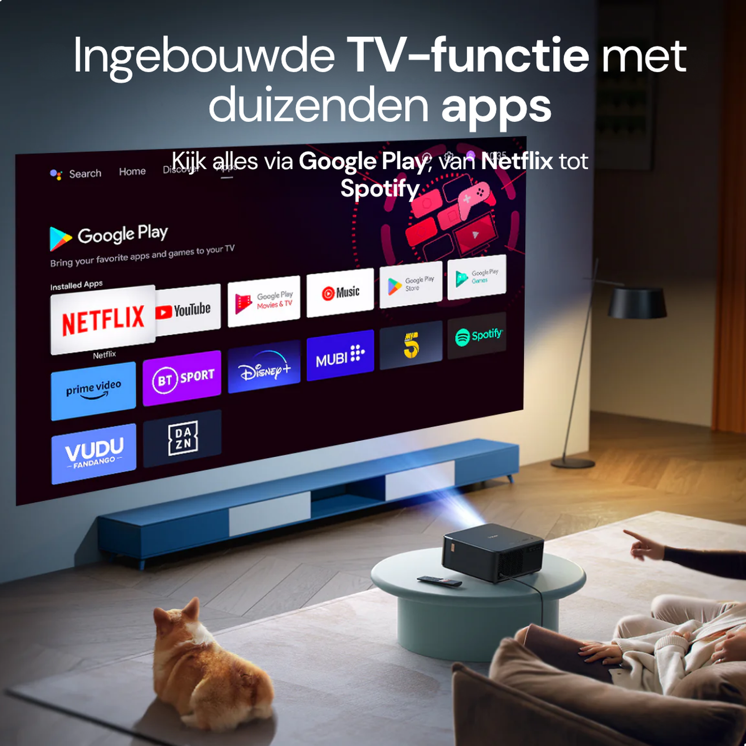 A projector displays a smart TV interface with apps on a screen. A dog sits in front.