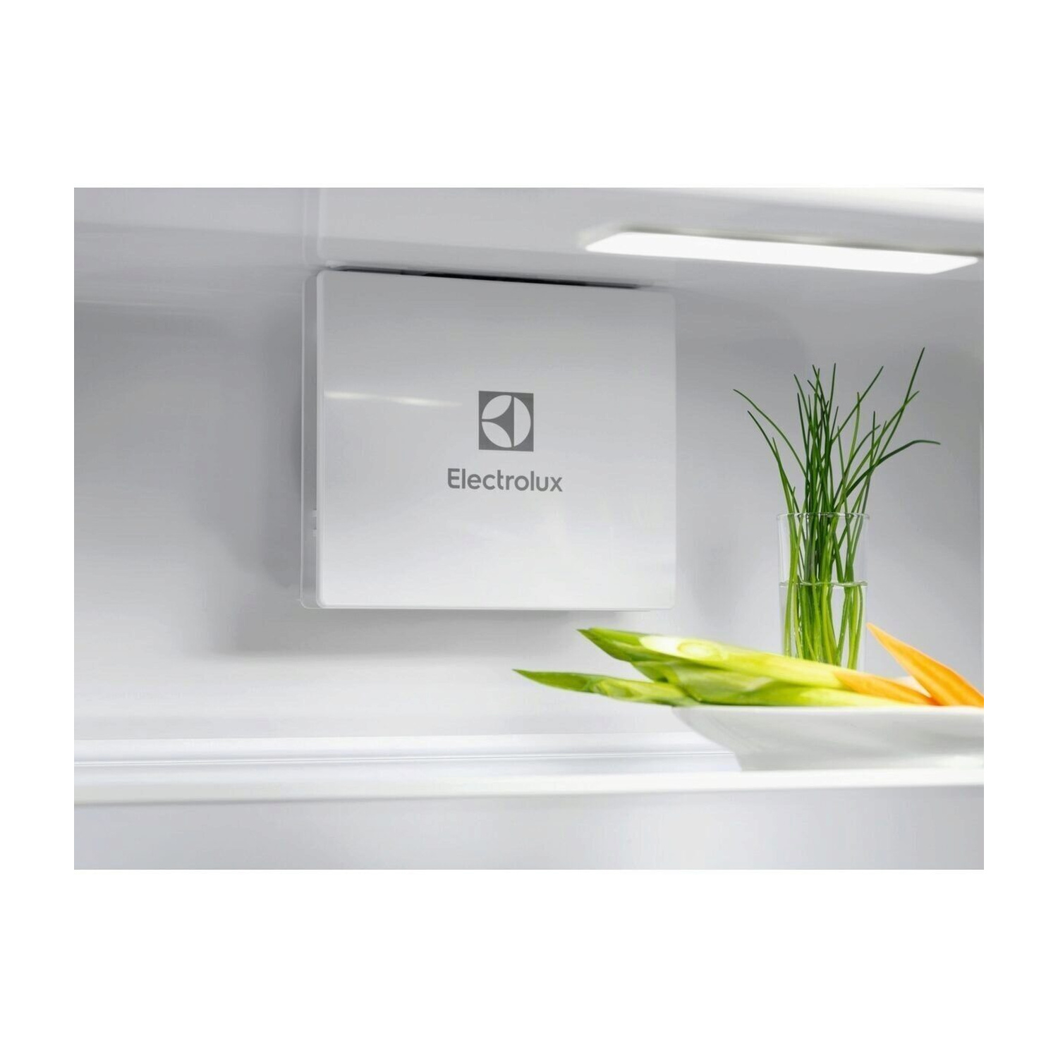 Scatola bianca con logo Electrolux e verdure su uno scaffale.