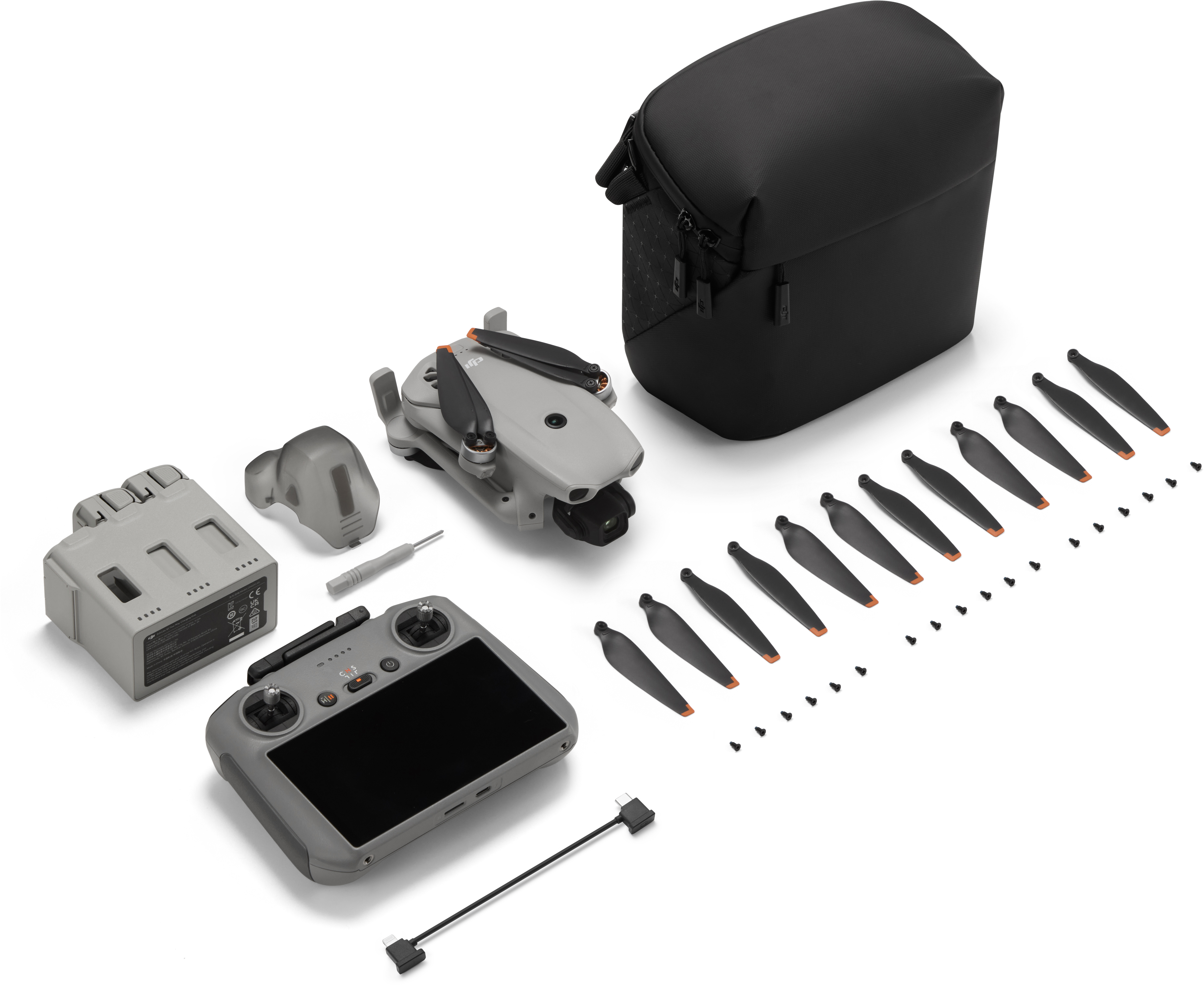 Kit mini drone grigio con telecomando, batteria, eliche e borsa.