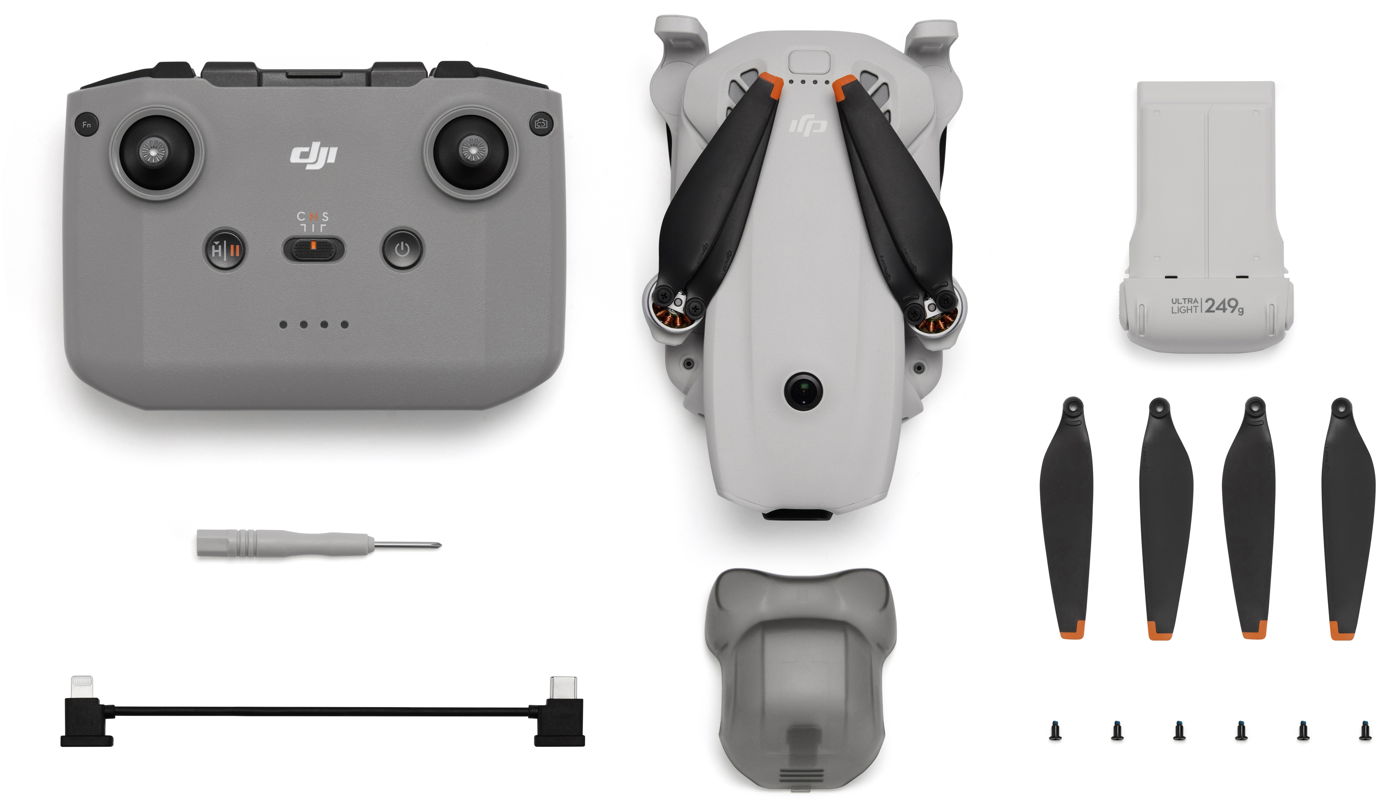 Kit drone DJI: controller, drone, batteria, eliche, viti, cavo e attrezzo.