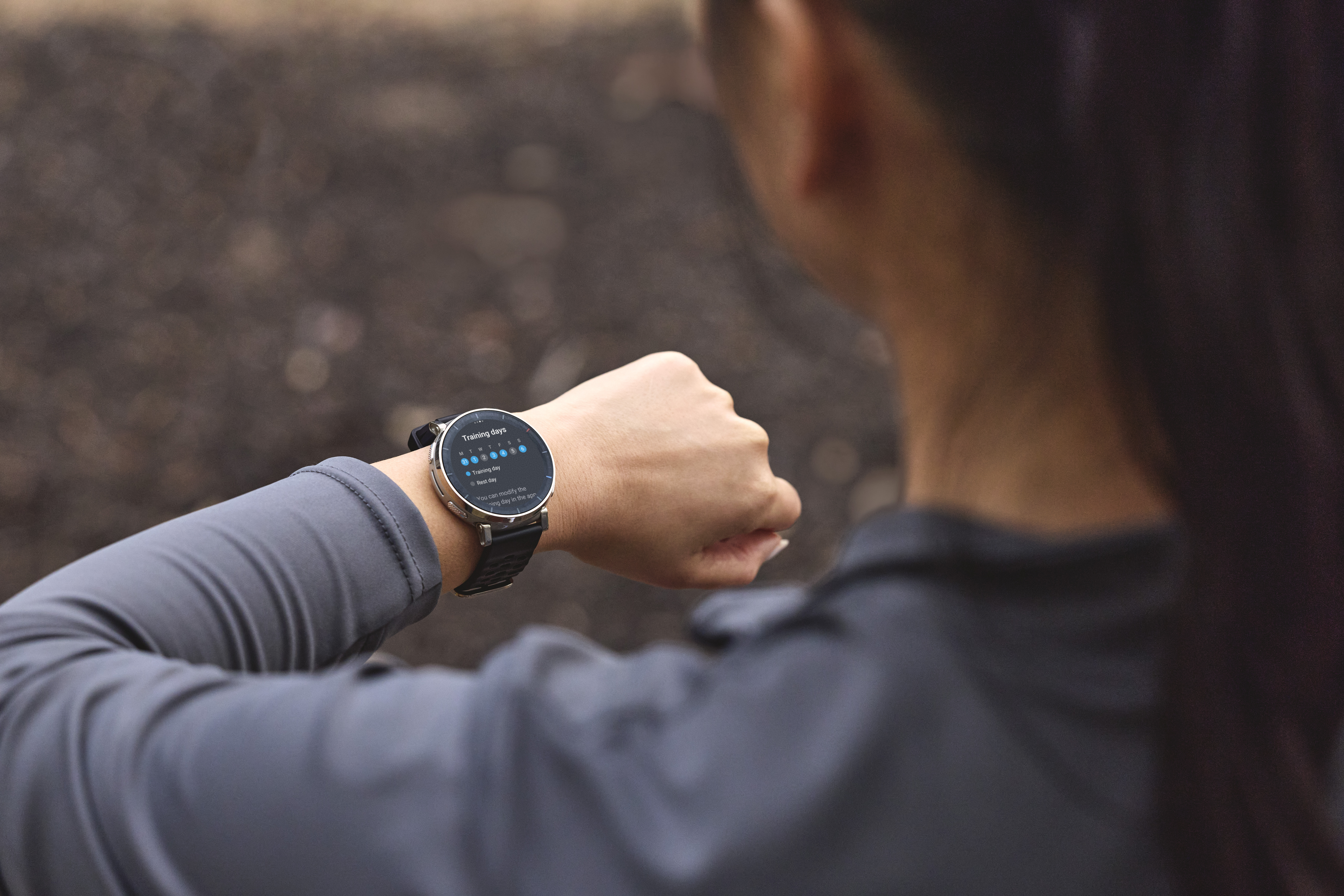 Eine Person trägt eine Smartwatch, die einen Trainingskalender anzeigt.