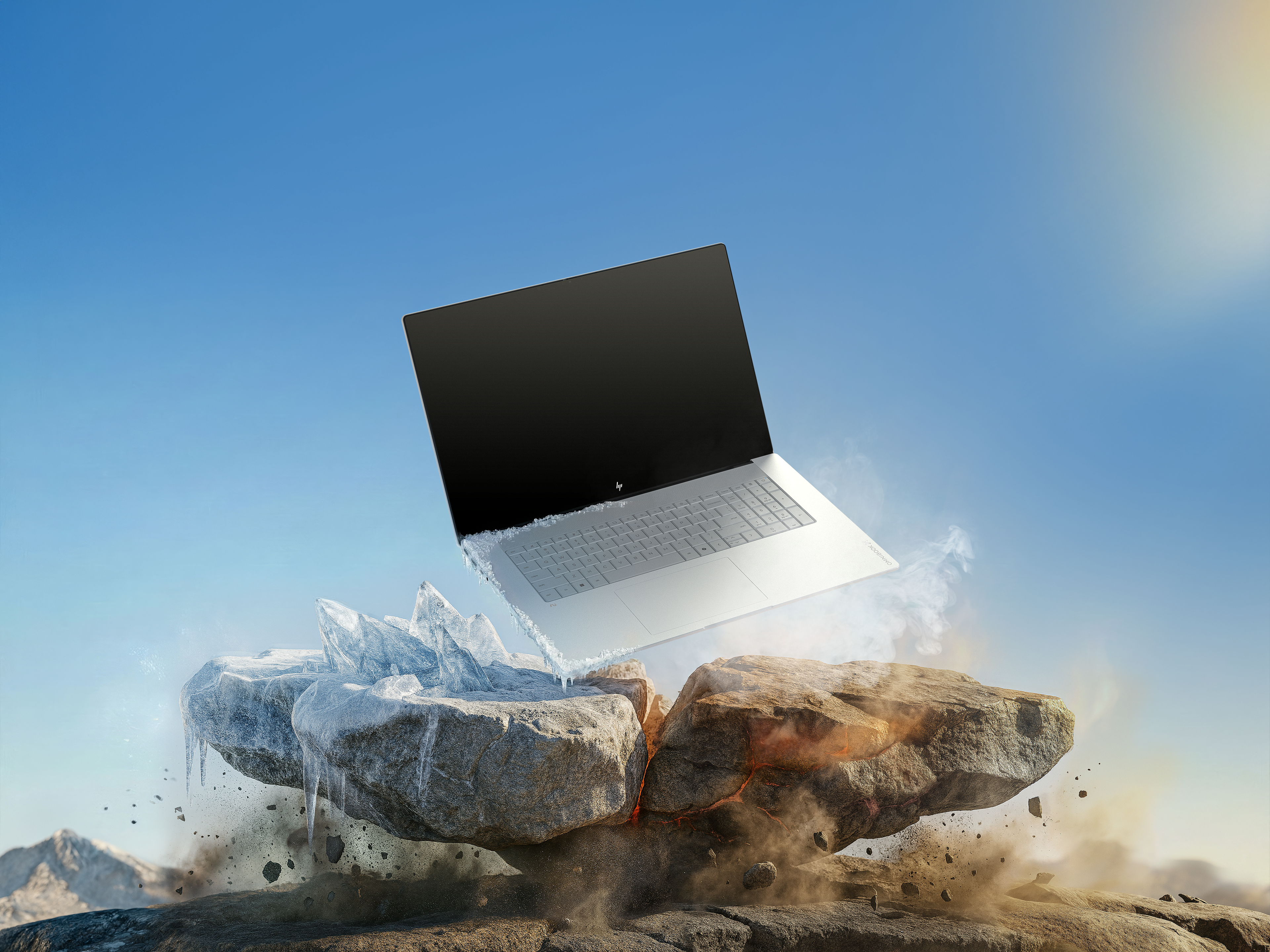 Laptop unosi się nad pękniętymi skałami, jedna lodowa, druga żarząca się, na tle błękitnego nieba.