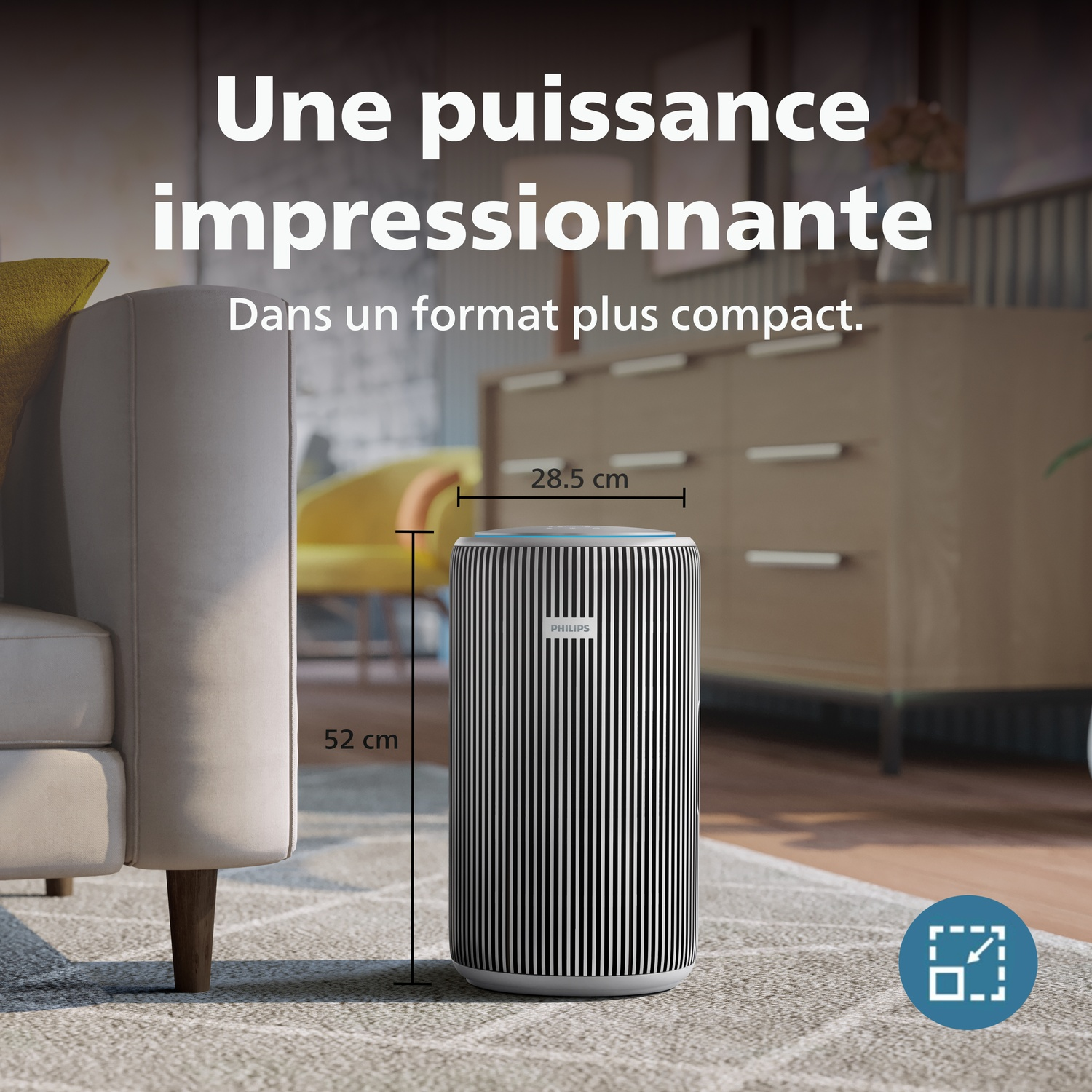 Un purificateur d'air Philips (52x28,5 cm) est sur un tapis à côté d'un canapé.