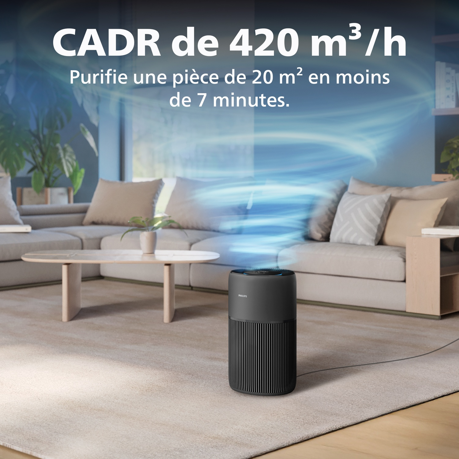 A black air purifier on a rug in a living room with sofas and a coffee table.